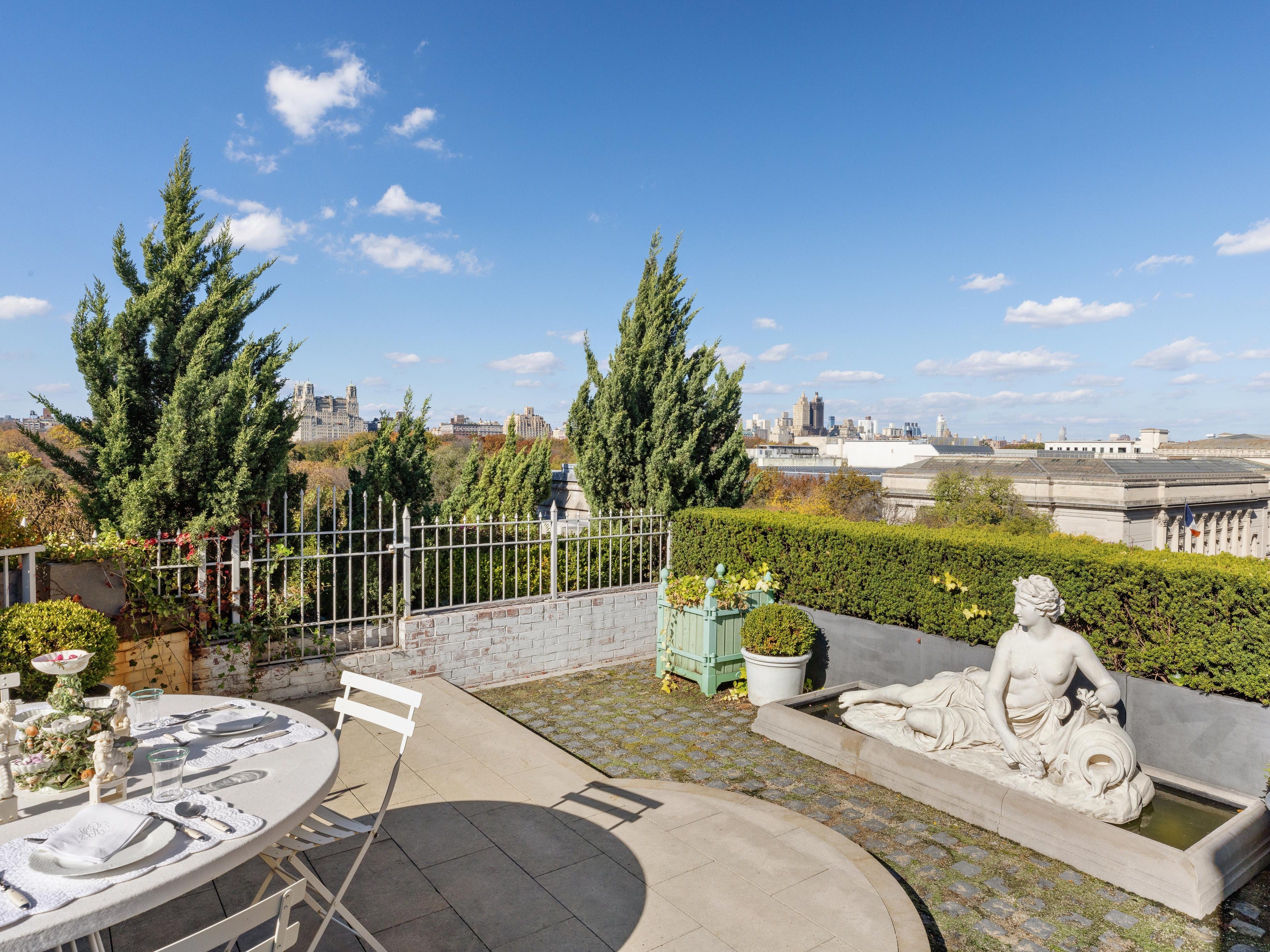 the private courtyard which features views of the met and an ornate statue