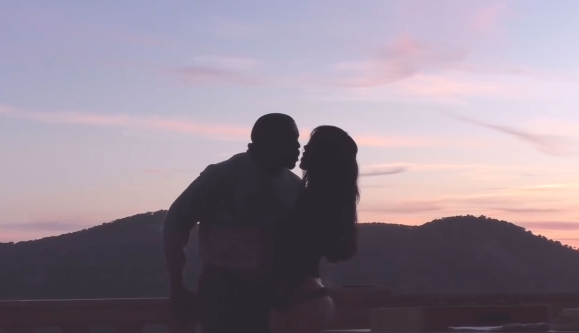 Bianca Censori and Kanye West kiss at sunset. 