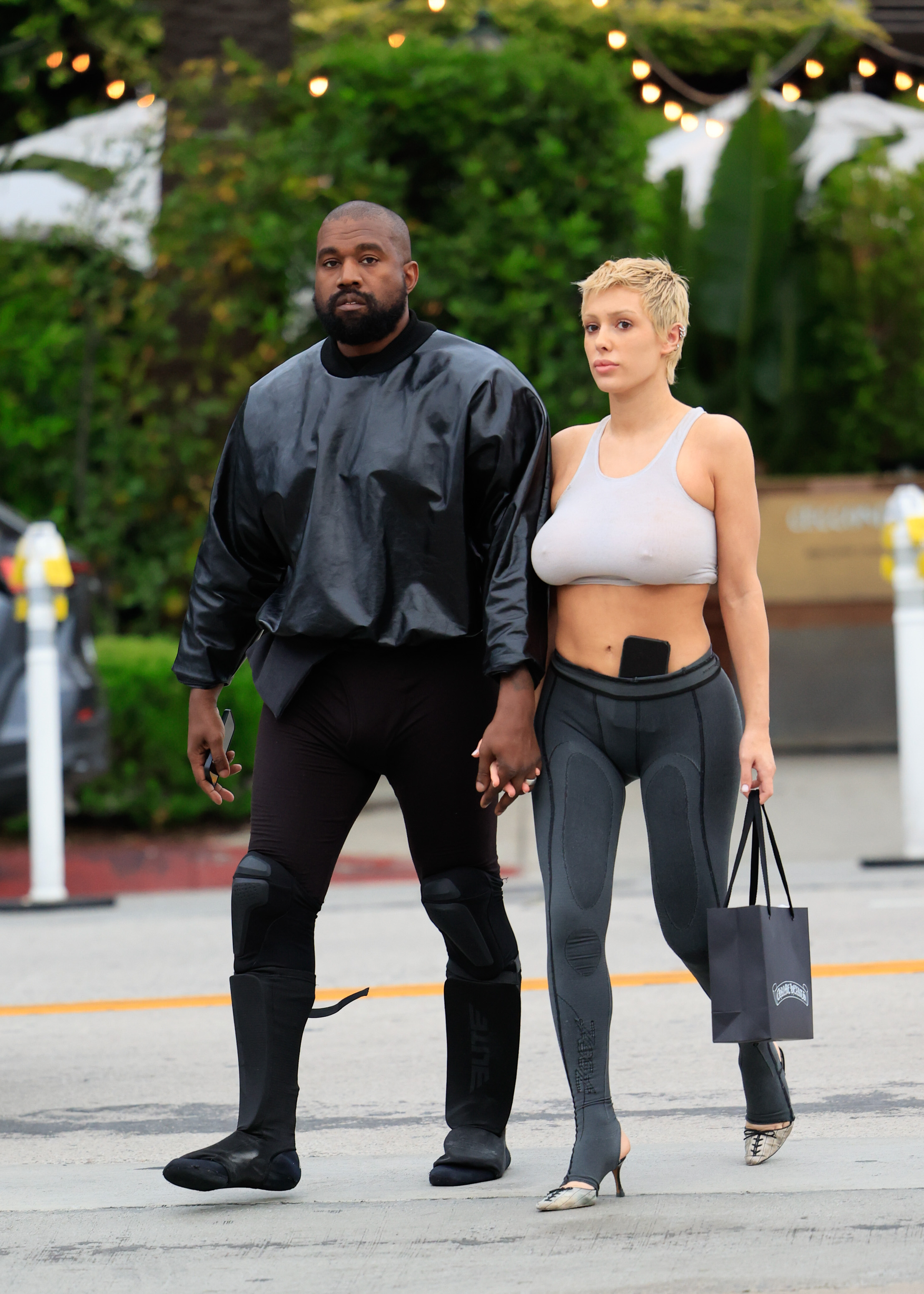 Kanye West holds hands with Bianca Censori. 