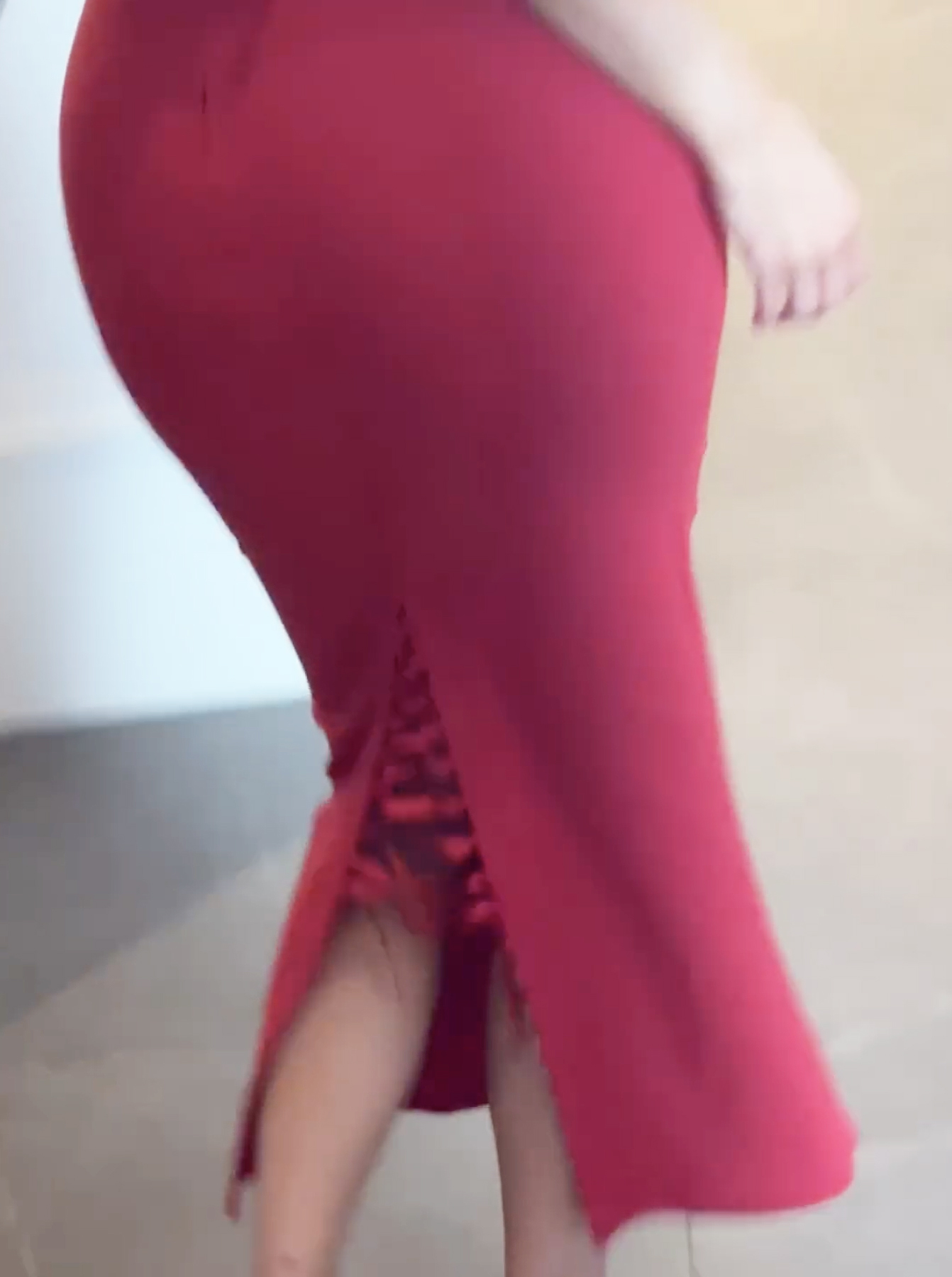 A red skirt with lace-up slit in back. 