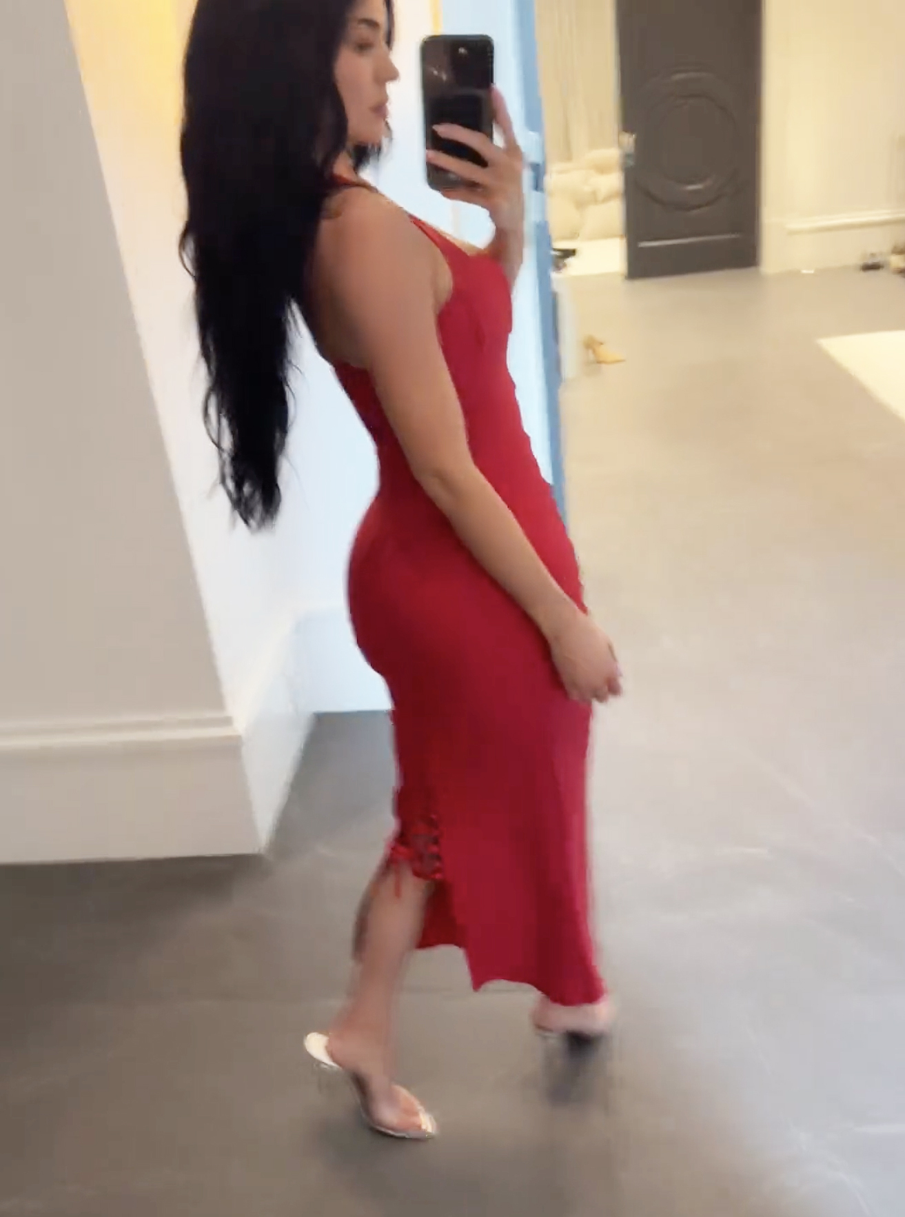 Kylie Jenner shows off the back of a red dress. 