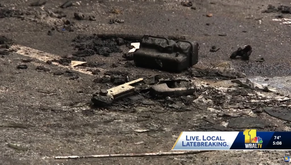 Charred car parts littered the parking lot of Tropic Bay Aquatic Garden Center in Davidsonville, Md..