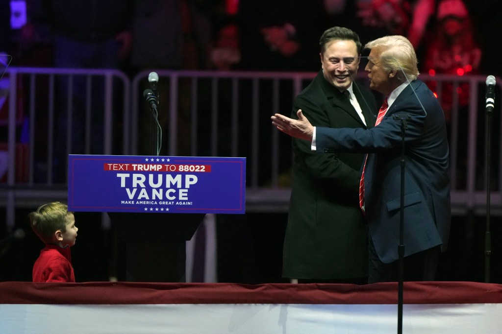 Musk, with his son X Æ A-Xii, arrives on the dais with President-elect Donald Trump, at a rally ahead of the 60th Presidential Inauguration, Jan. 19, 2025, in Washington.