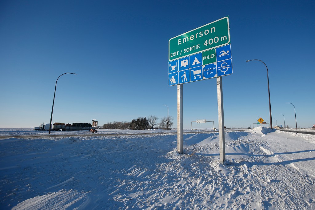 Road signage is posted just outside of Emerson, Manitoba, Thursday, Jan. 20, 2022.