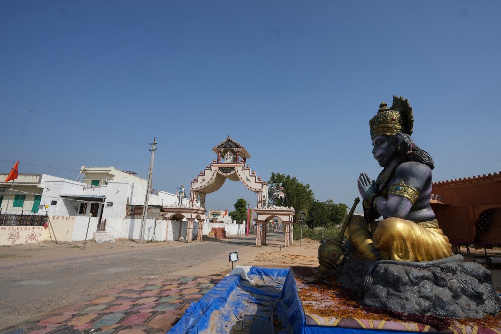 A statue of Monkey God Hanuman, installed as part of a religious celebrations, is seen in front of an entrance gate of Dingucha village in Gandhinagar, India, Tuesday, Nov. 12, 2024.
