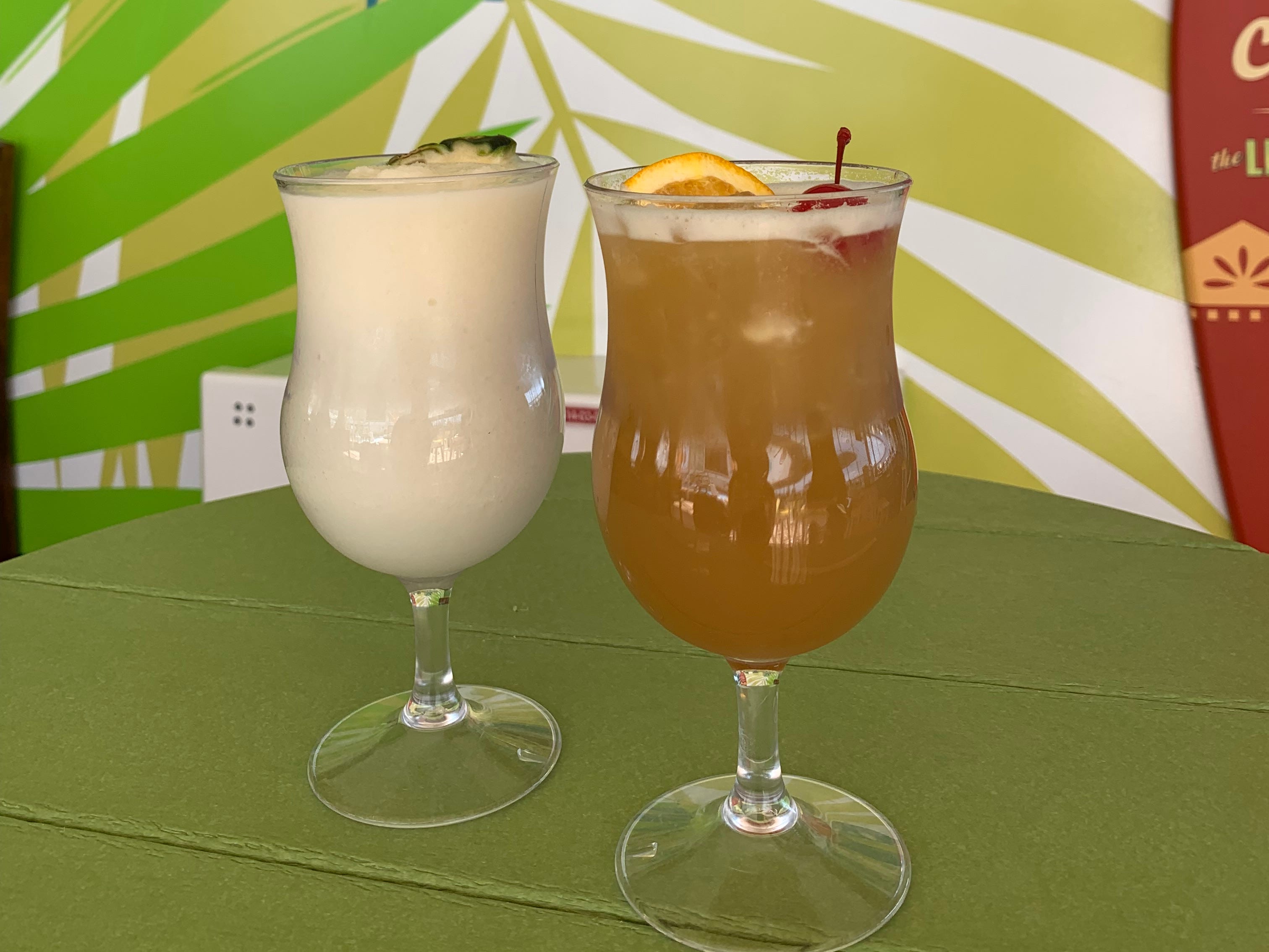 Two tropical drinks in glasses.
