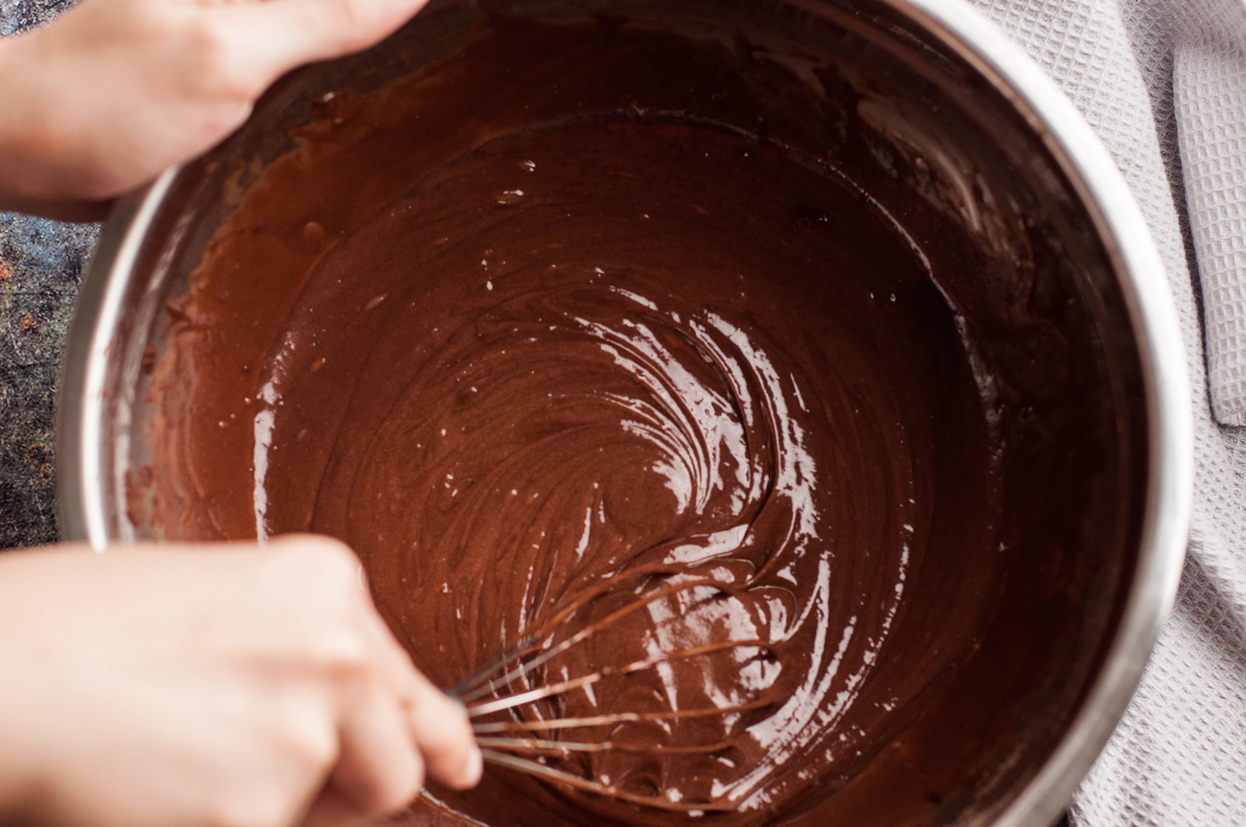 Whisking brownie mix in metal bowl