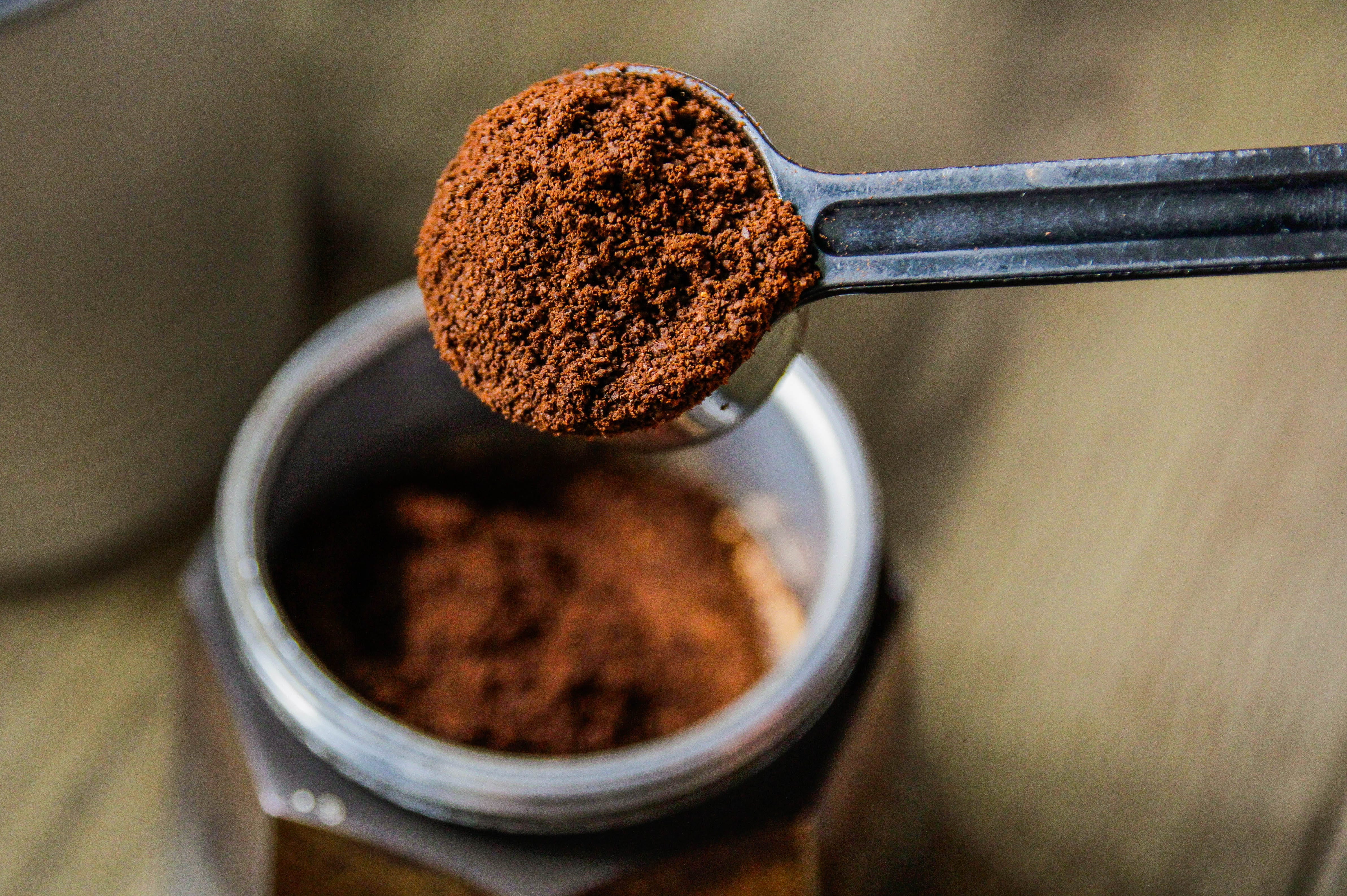 scoop full of espresso powder over a jar of espresso powder
