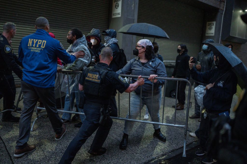 Protesters confronting police officers and pushing against barricades at the Varick ICE facility in Manhattan, New York during a demonstration on 28 May 2025