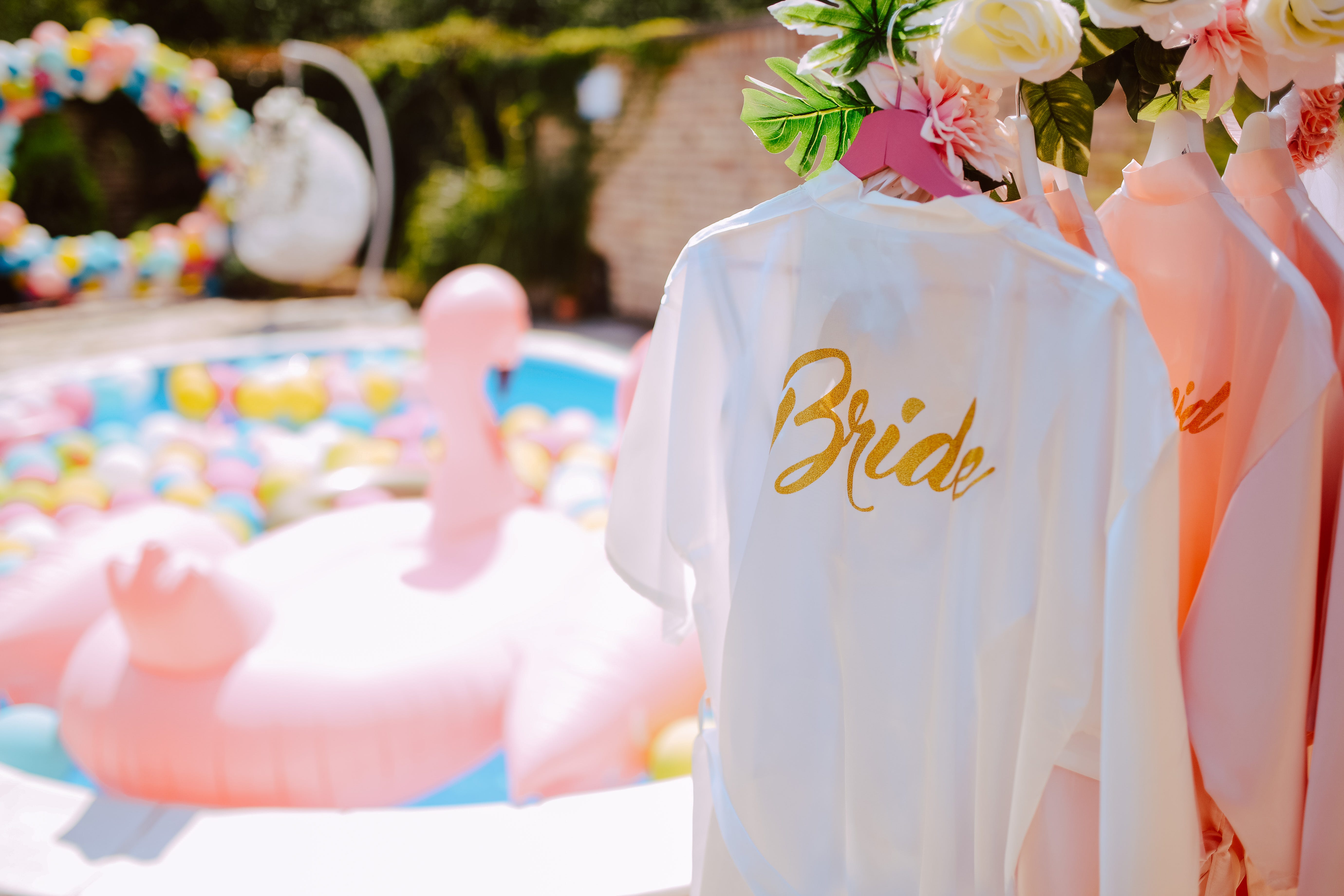 Bride robe hanging next to pool