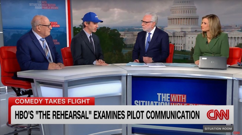 Comedian Nathan Fielder and aviation safety expert John Goglia with Wolf Blitzer and Pamela Brown on CNN. 