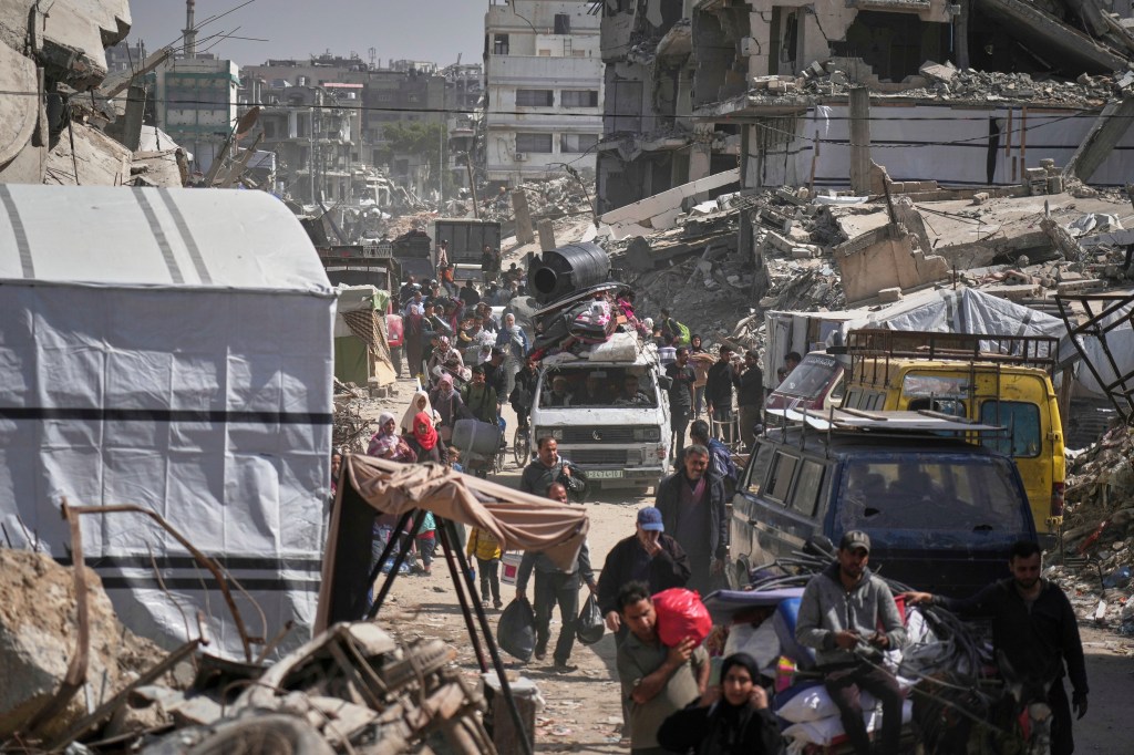 Palestinians carry their belongings as they evacuate the Shijaiyah neighborhood following evacuation warnings issued by the Israeli army, in Gaza City,on Thursday, April 3, 2025.