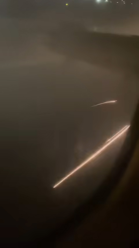 Sparks and smoke shoot off the plane after the landing in Orange County, California.