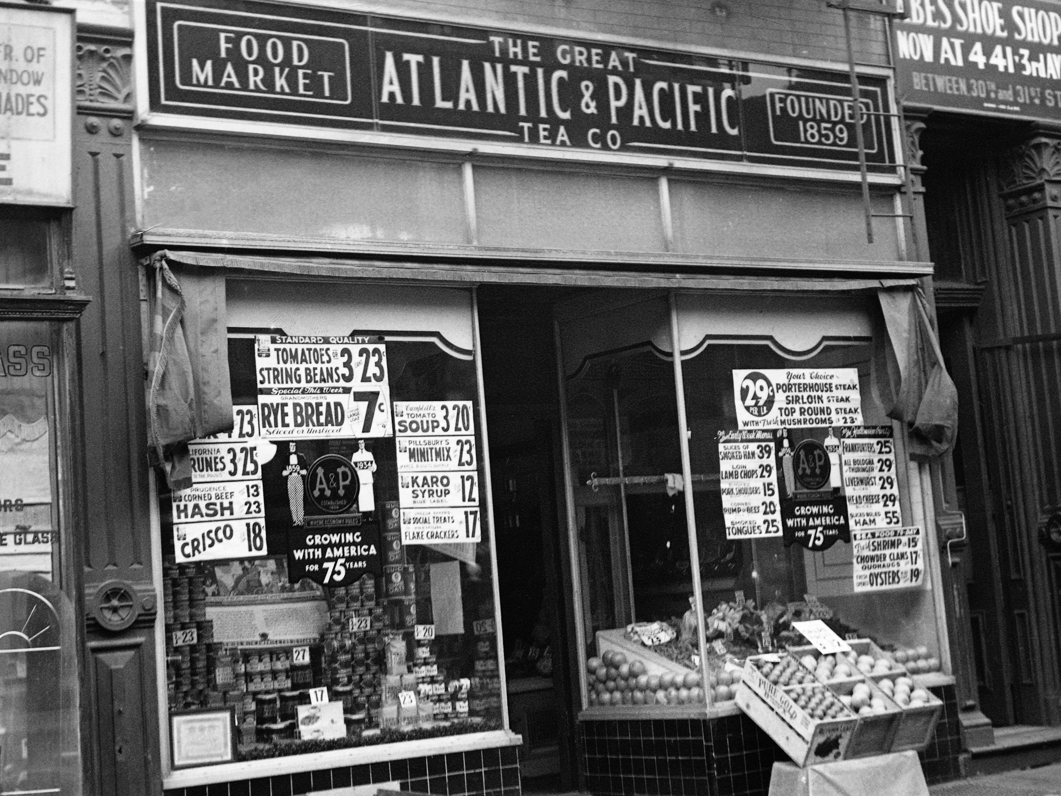 A small storefront with advertisements on the windows and food on display