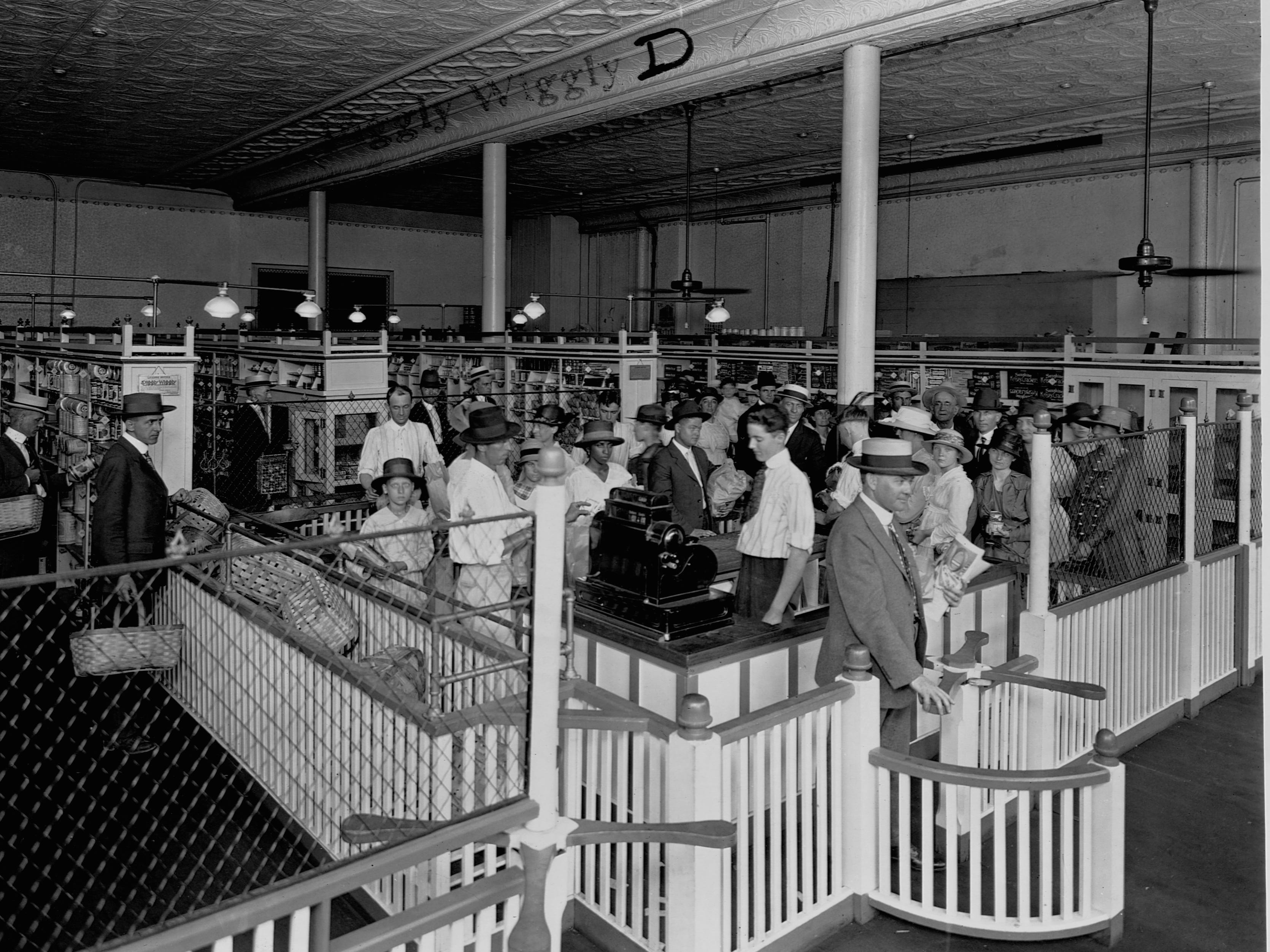 People crowded around a checkout counter at a grocery store