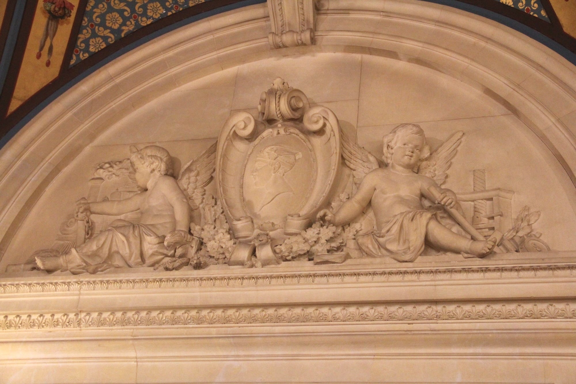 An engraving above a door showing angels with locomotives at The Breakers.