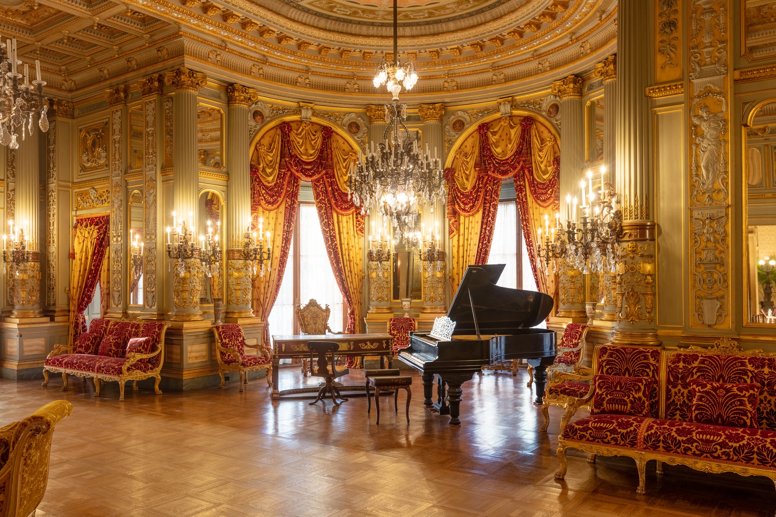 The Music Room at The Breakers, with a grand piano and ornate gilded walls.