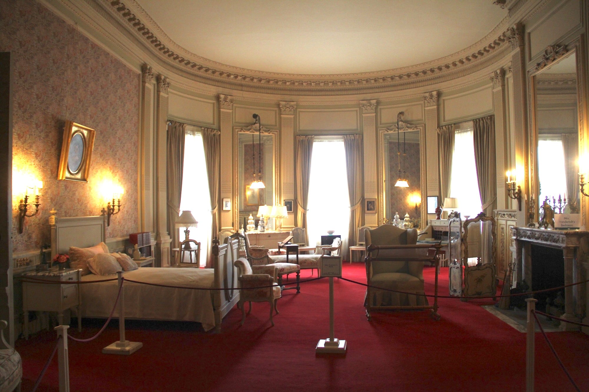 A bedroom with red carpeting at The Breakers.