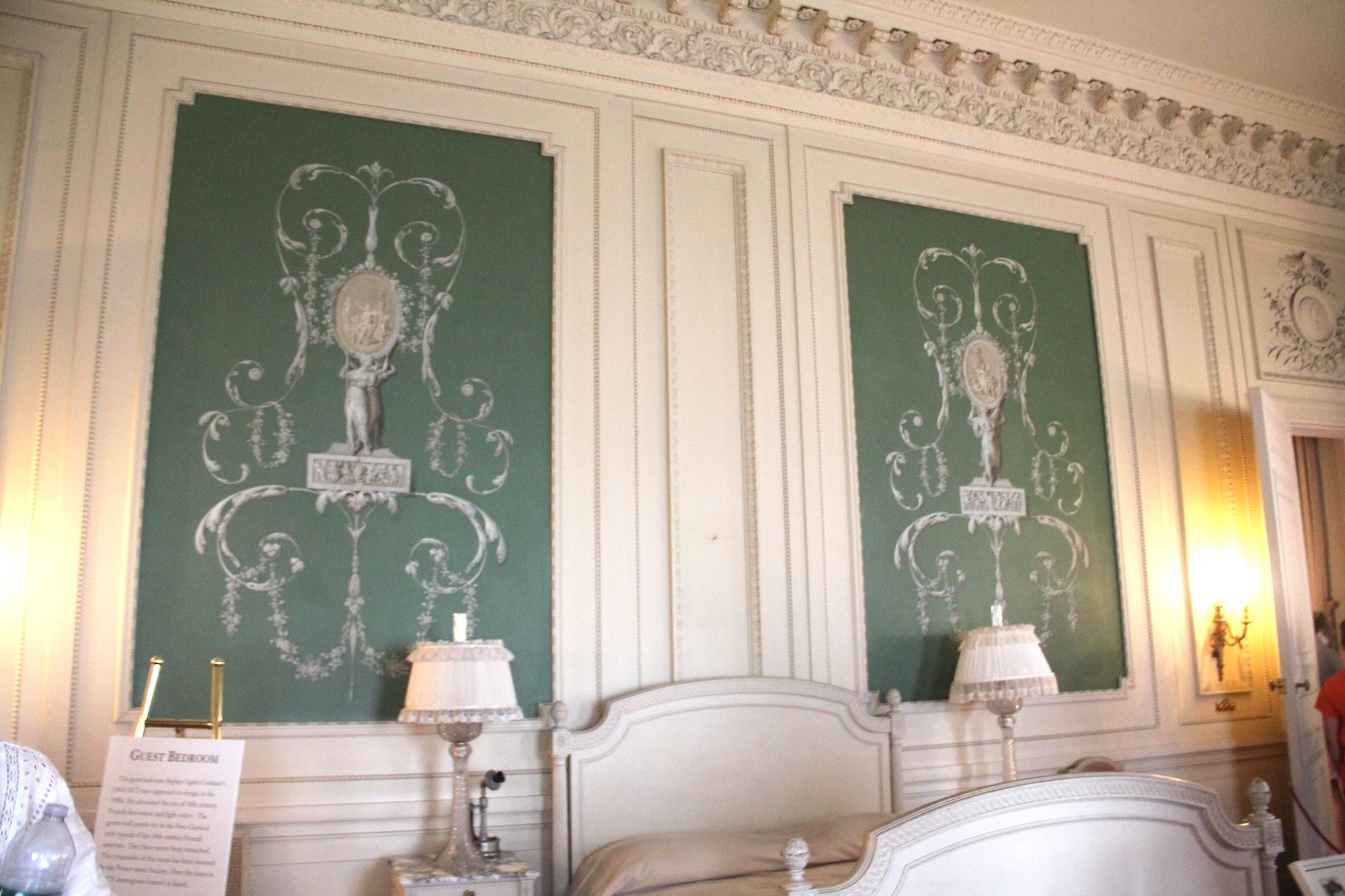 A bedroom with green walls at The Breakers.