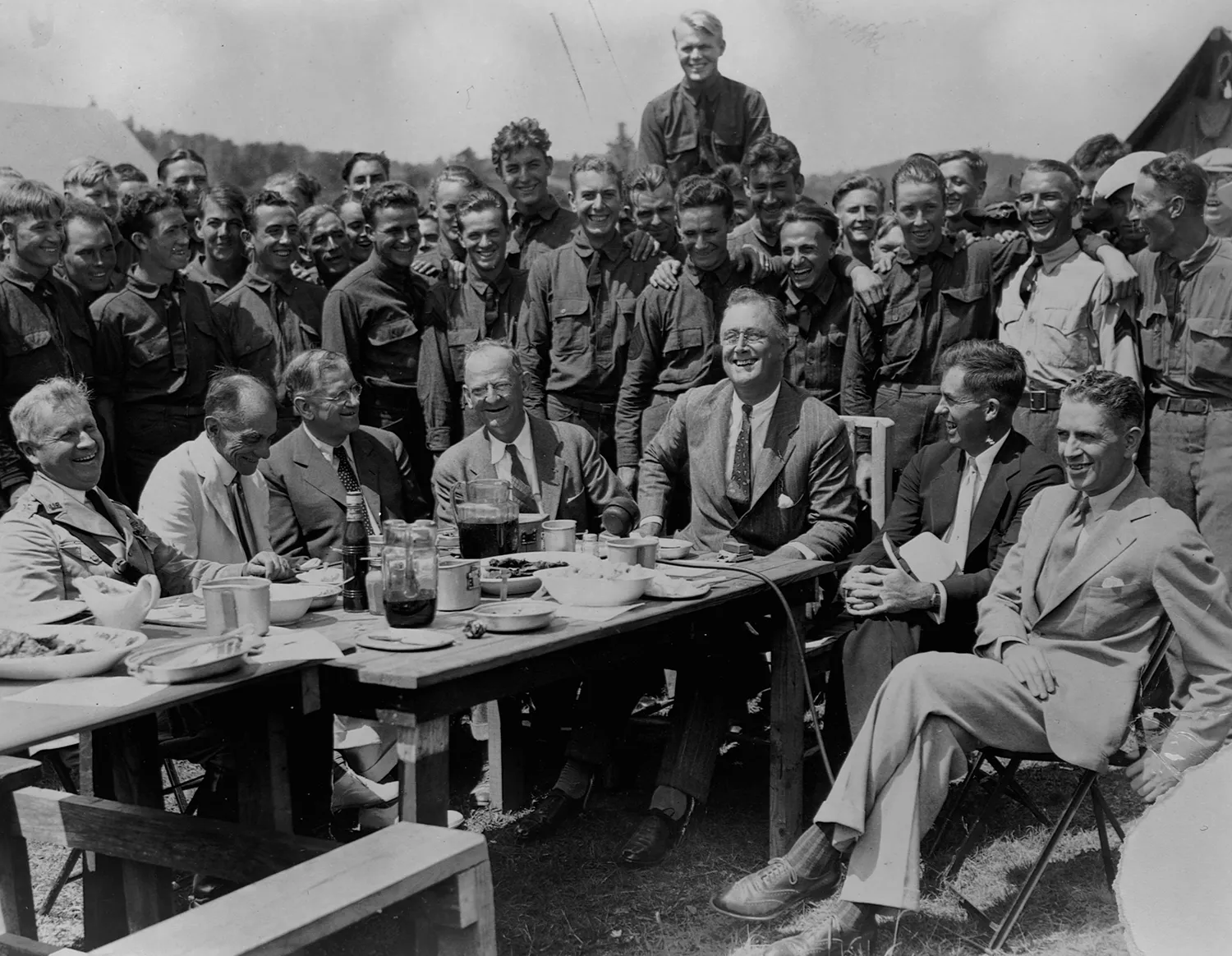 President Franklin D. Roosevelt visits a Civilian Conservation Corps Camp in a historic photograph.