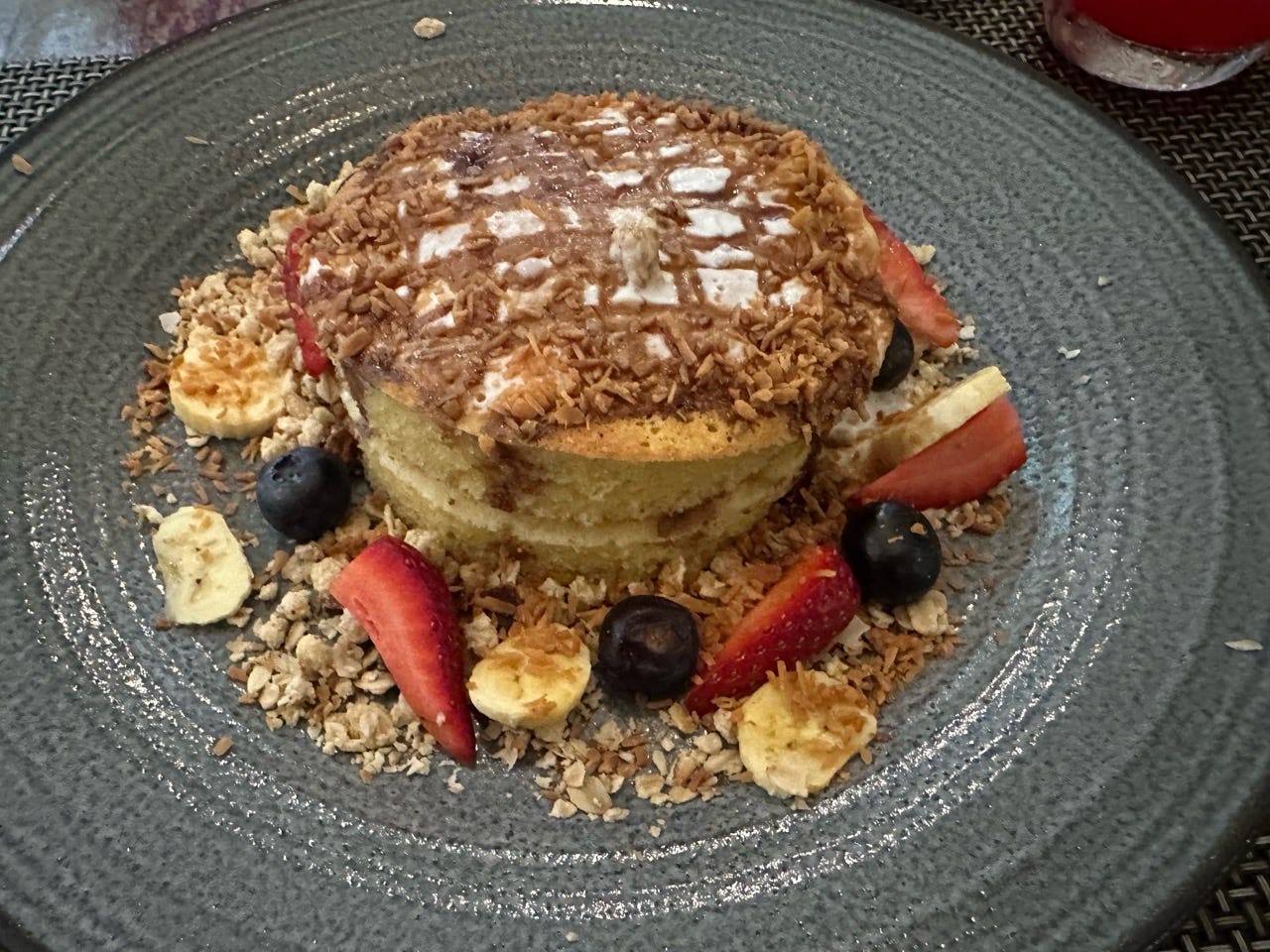 Puffy pancake with chocolate drizzle, fruit