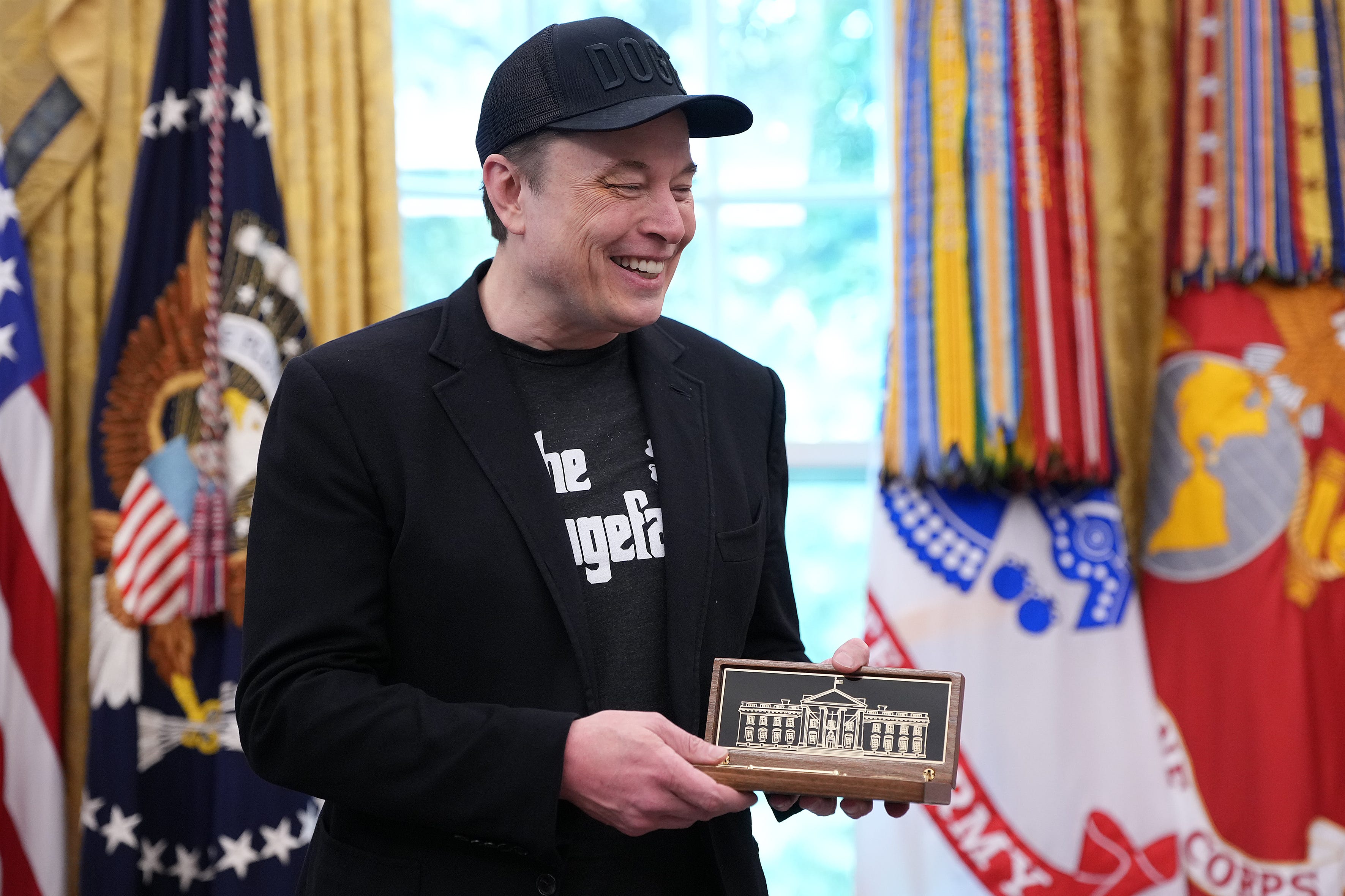 Elon Musk accepts a key from President Donald Trump in the Oval Office on May 30, 2025.