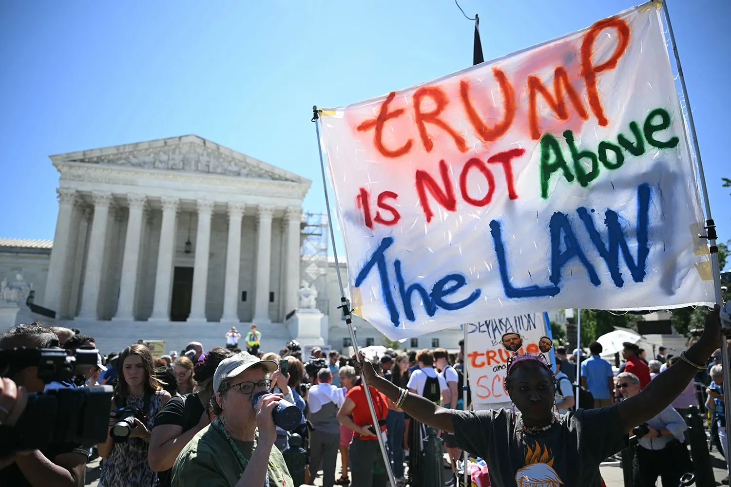 Protesters in front of the U.S. Supreme Court hold a sign that reads 