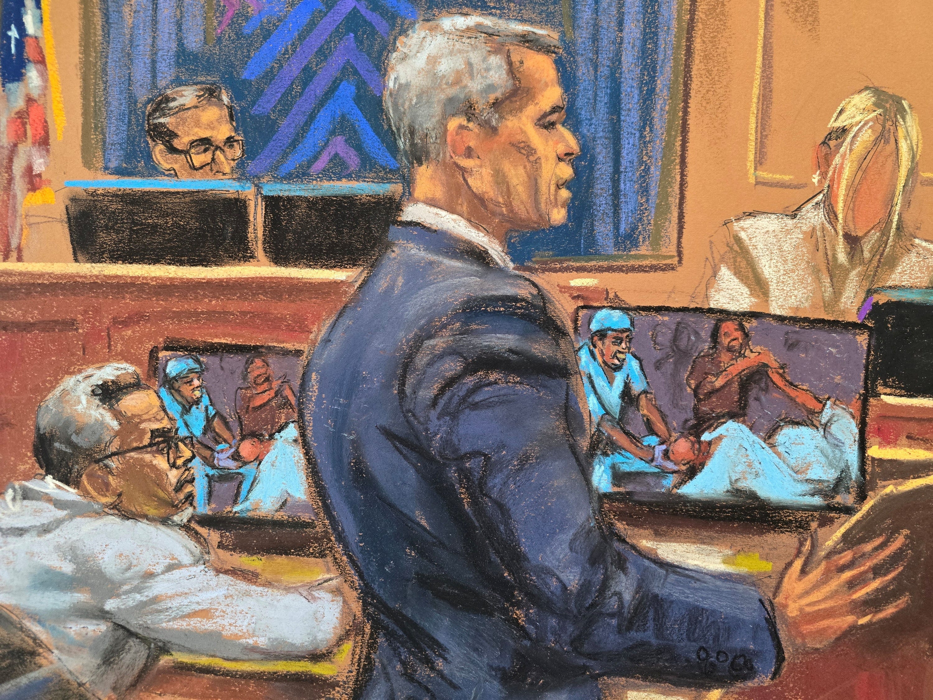Sean "Diddy" Combs listens from the defense table as his lawyer, Brian Steel. cross-examines "Mia," who accuses Combs of repeatedly sexually assaulting her when she worked for him as a personal assistant and film executive.