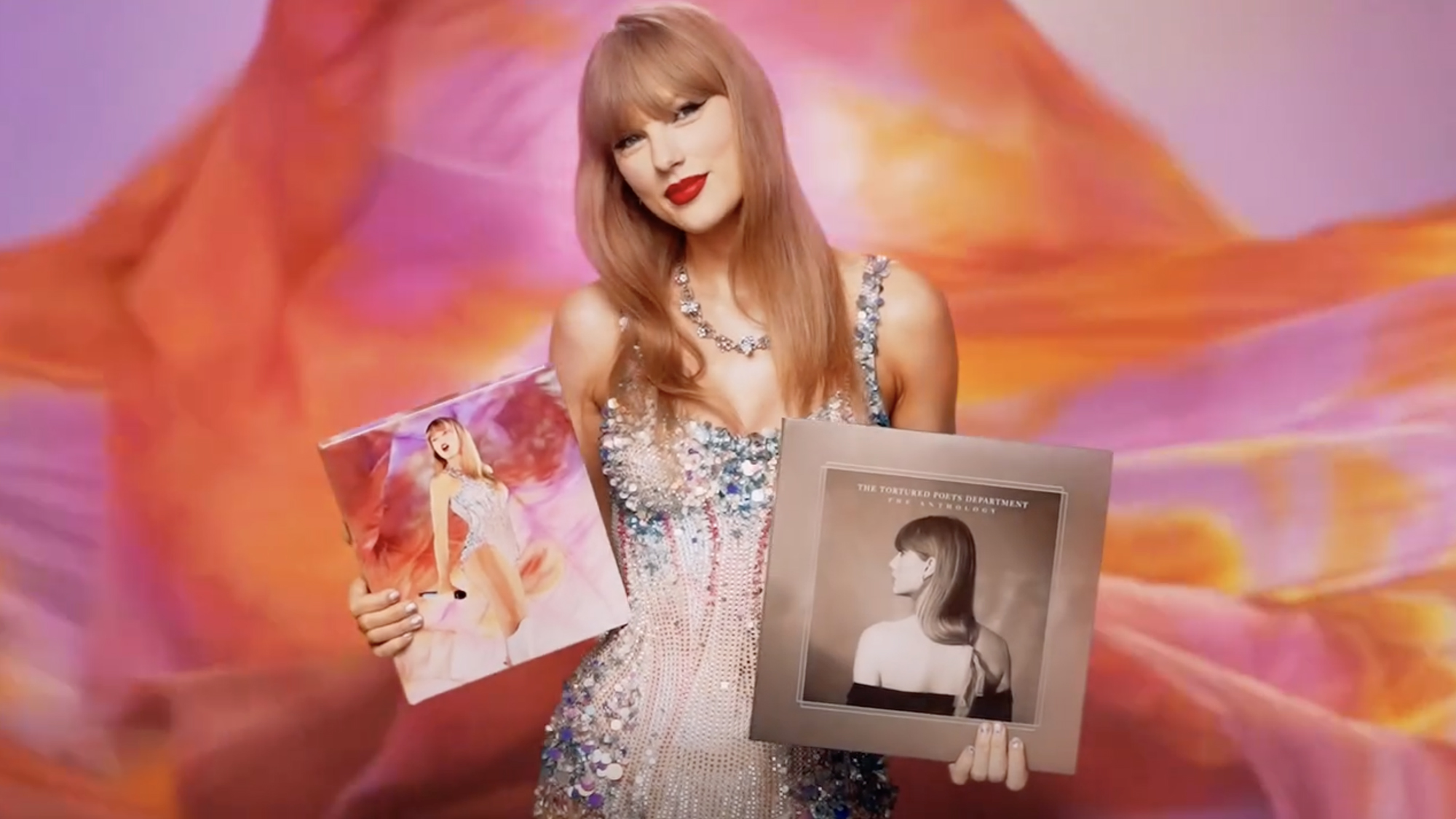 Taylor Swift holding her albums