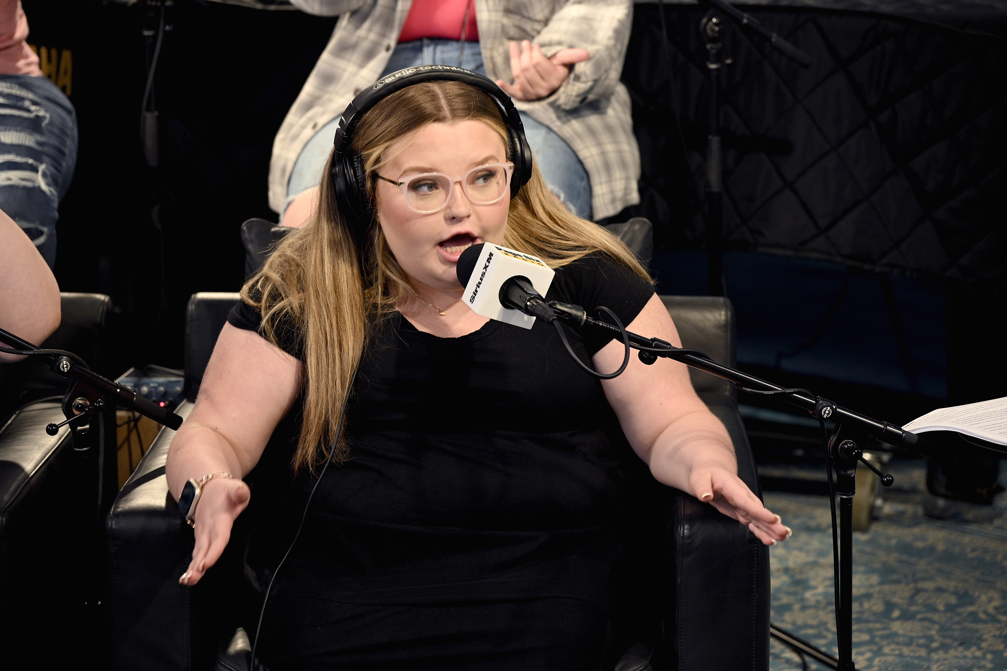 Alana Honey Boo Boo speaking into a mic while sitting in a chair. 
