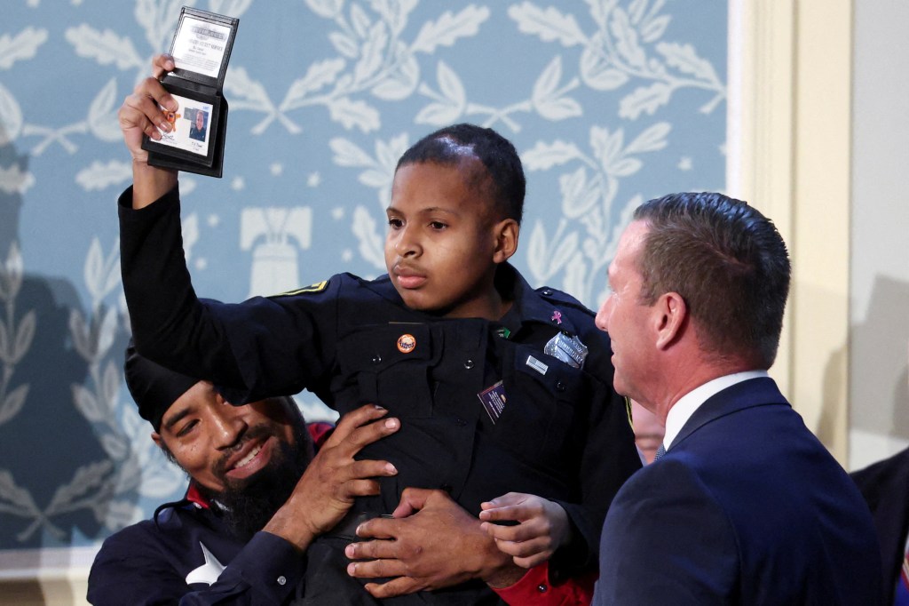 Devarjaye “DJ” Daniel, 13,  after being sworn in as an honorary Secret Service agent.