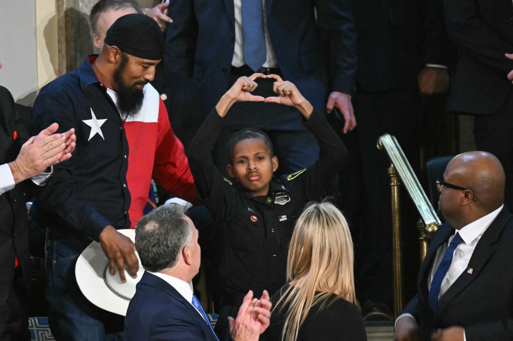 DJ gestures to the camera after being recognized in an address by President Trump.