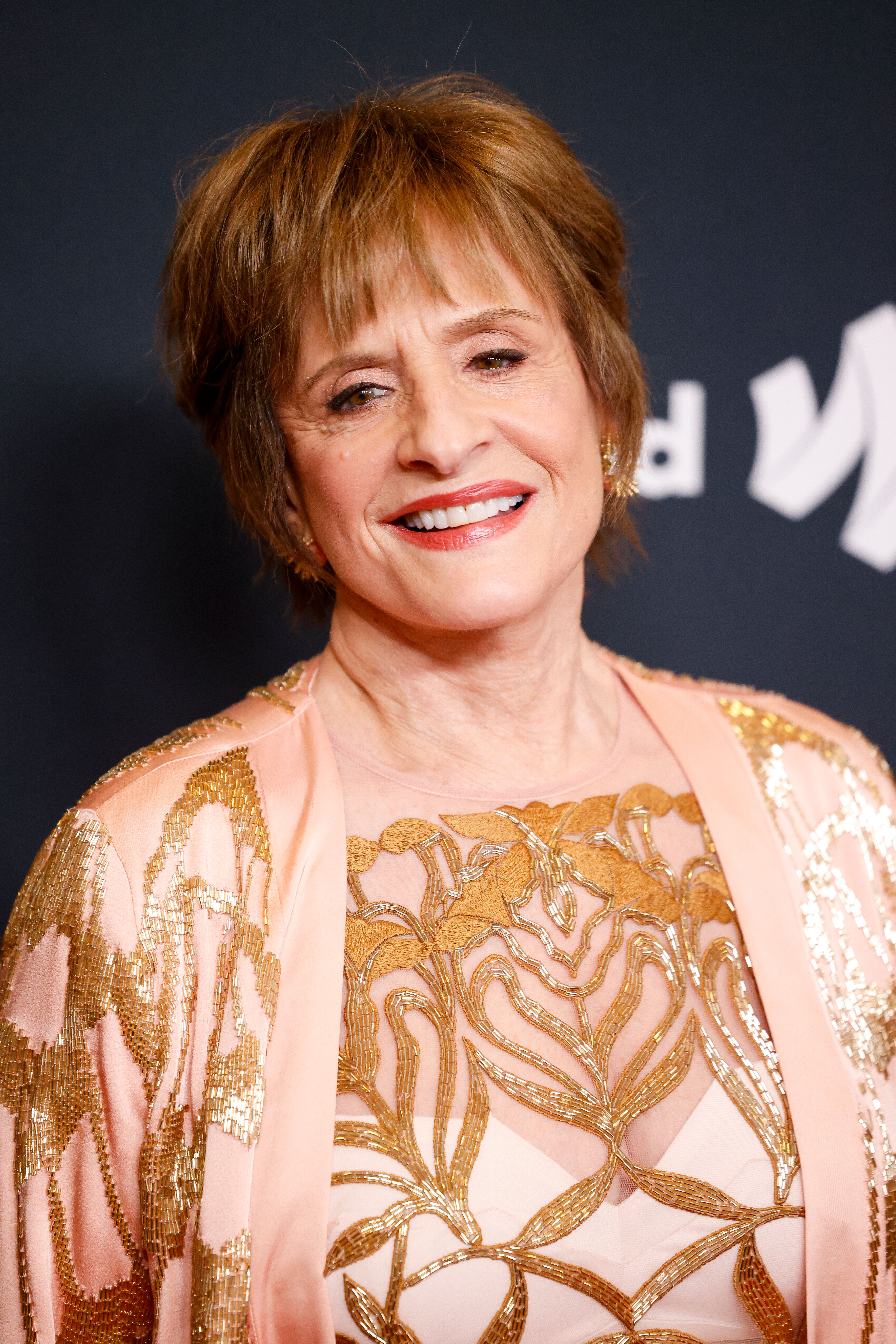 Patti LuPone smiles at an event. 