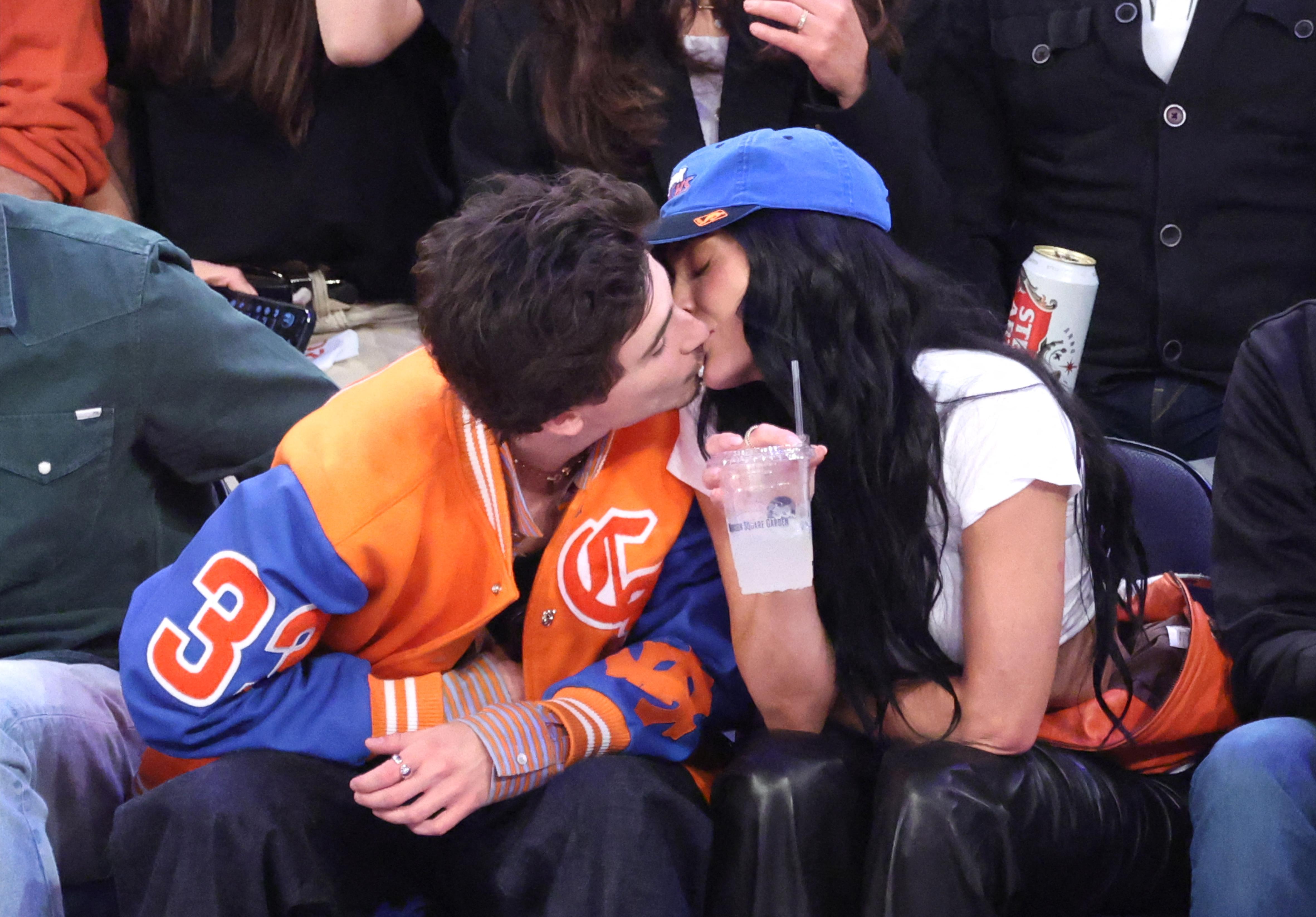 Kylie Jenner and Timothee Chalamet kiss courtside. 