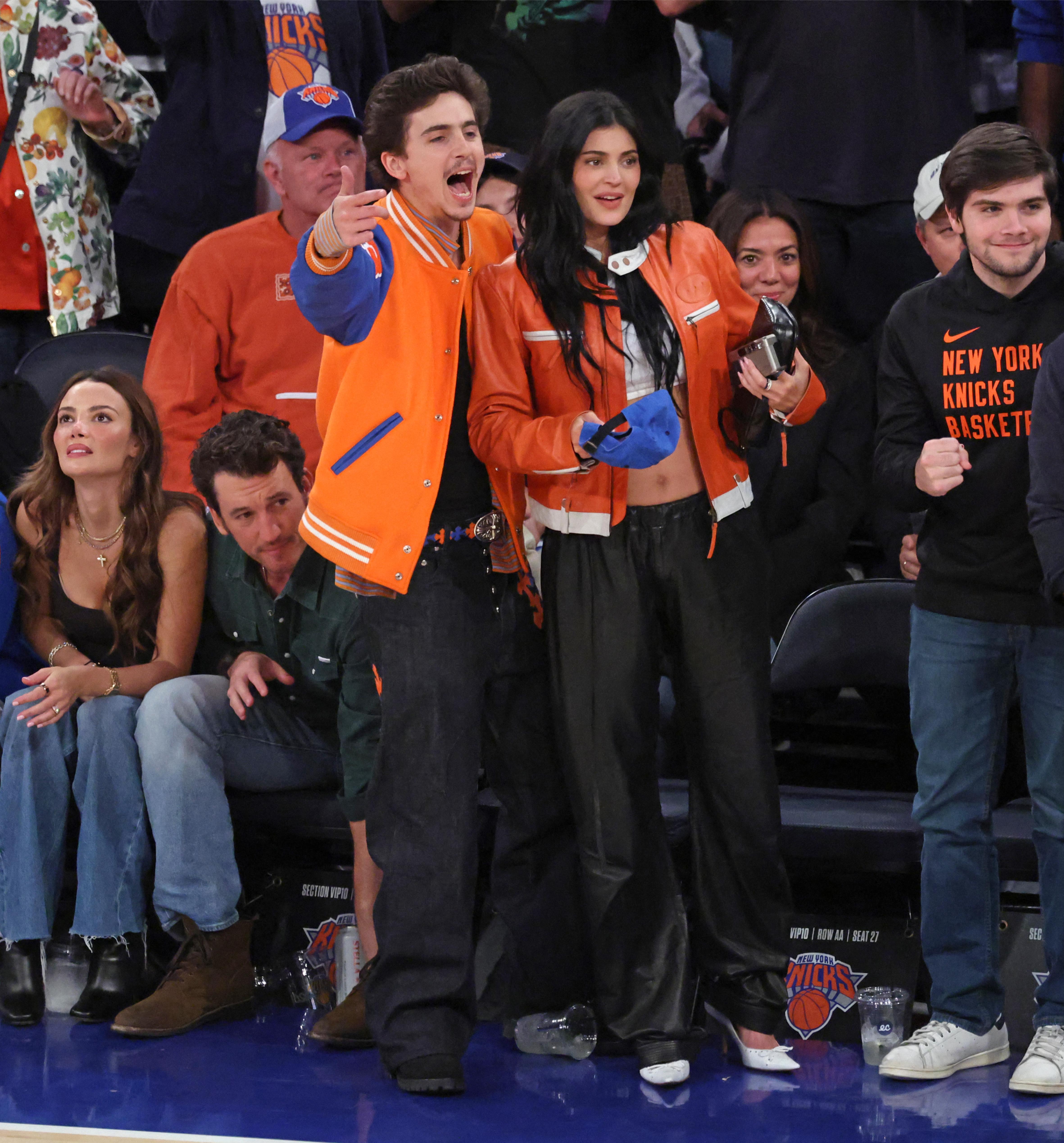 Timothee Chalamet and Kylie Jenner cheer courtside. 