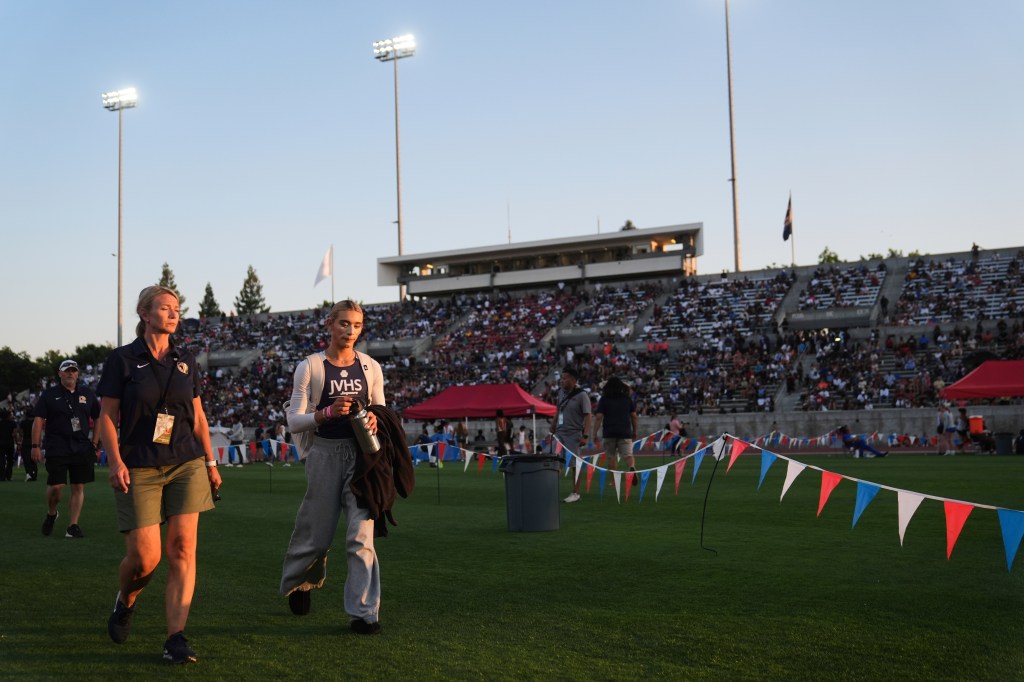 AB Hernandez leaves the stadium as a large crowd sits in the stands.