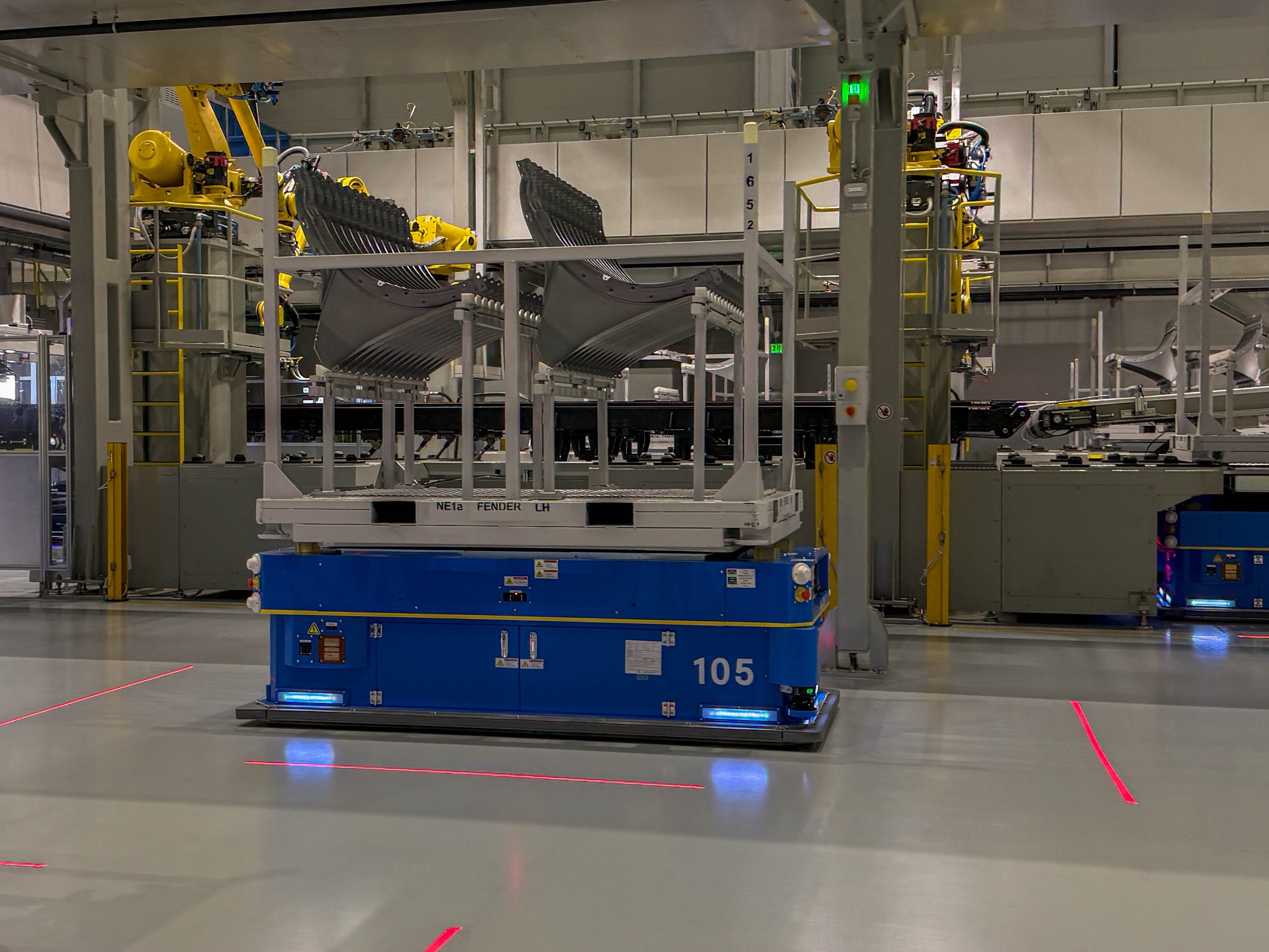 Autonomous robots transporting stamped metal parts at the Hyundai Motor Group Metaplant America in Georgia.