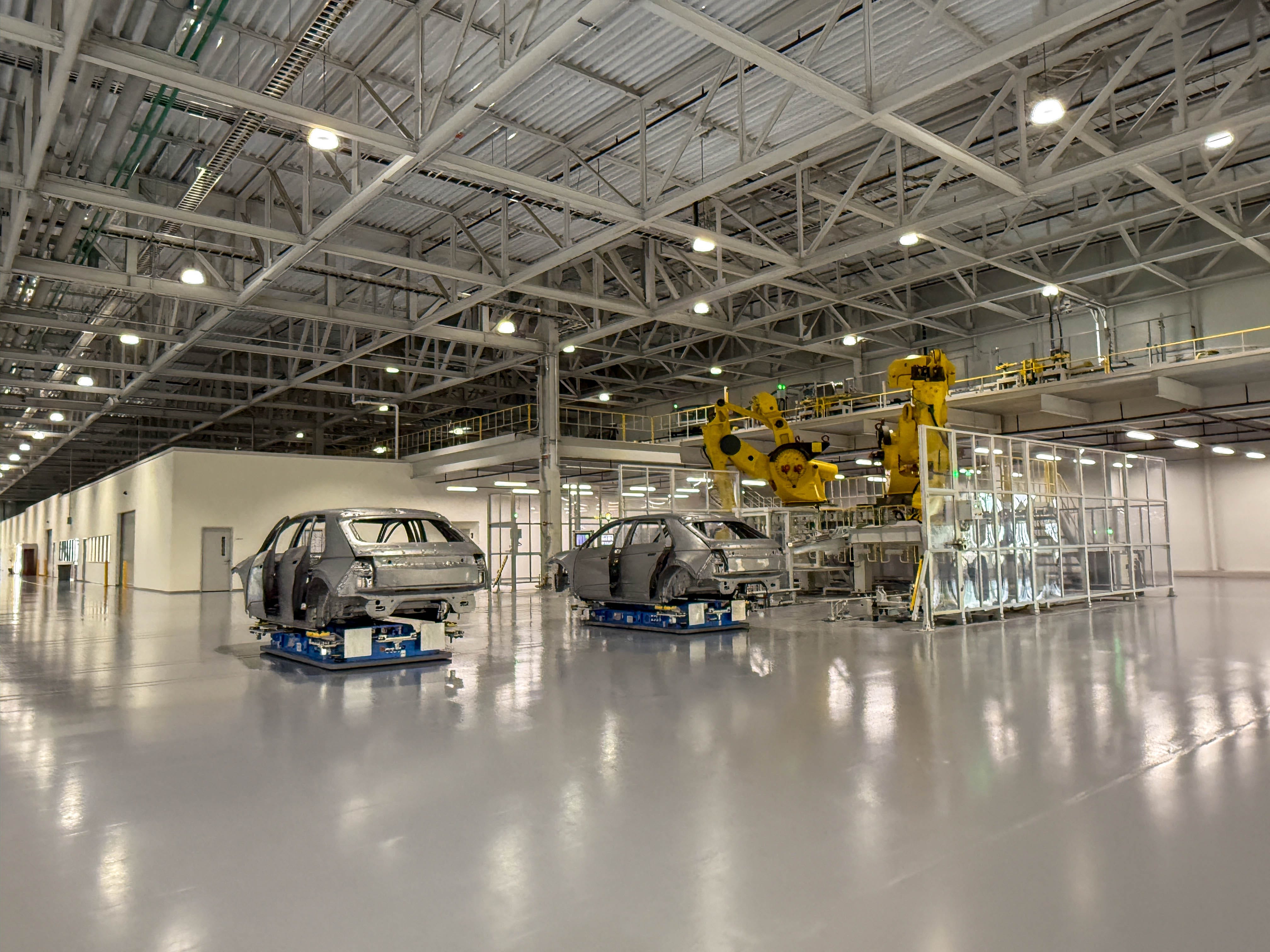Hyundai Ioniq 5 EVs are about to be lifted on the conveyor belt to the paint shop at the Hyundai Motor Group Metaplant America in Georgia.