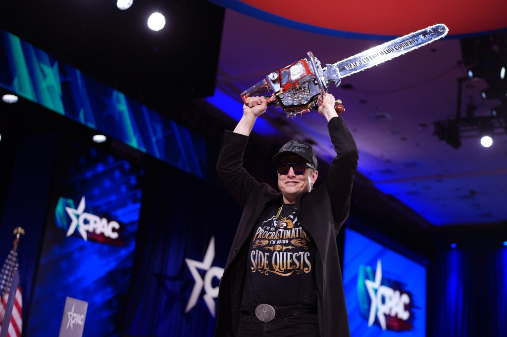 Musk leaves the stage holding a chainsaw after speaking at the Conservative Political Action Conference (CPAC) at the Gaylord National Resort Hotel And Convention Center on February 20, 2025 in Oxon Hill, Maryland. 