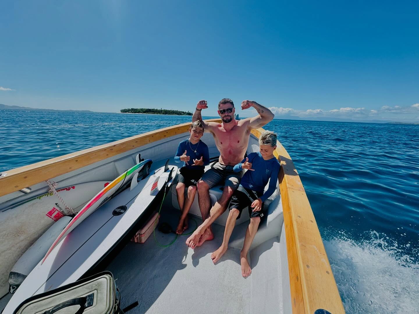 Chris Hemsworth is ready to hang 10 in Fiji with 11-year-old twin sons Sasha and Tristan.