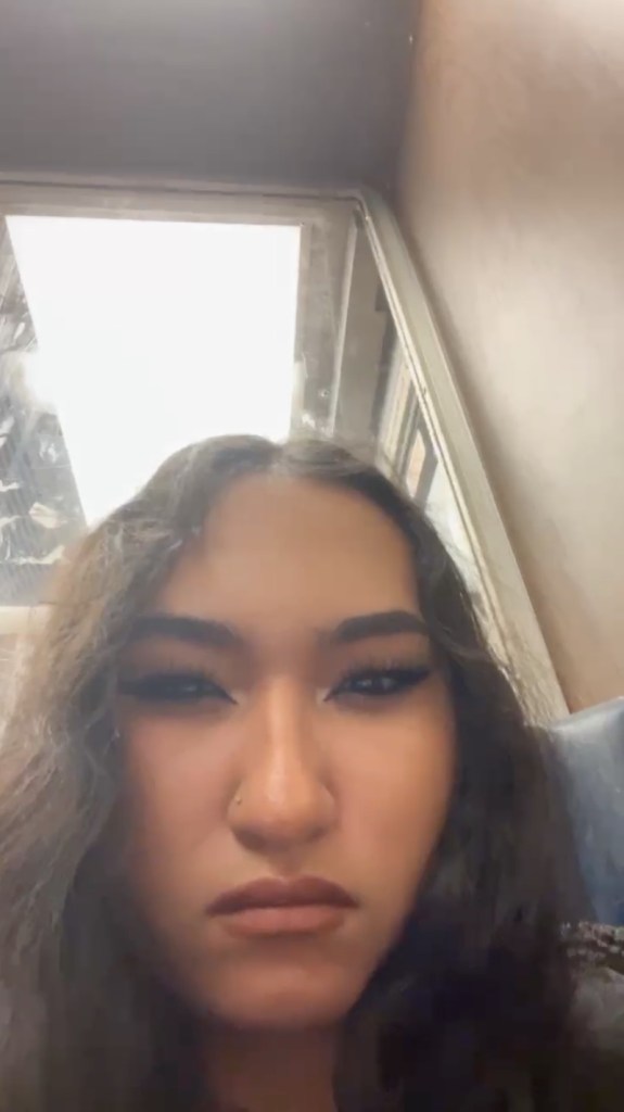 Screenshot of video shows close-up of Kaylin Morales's face looking annoyed while riding the LIRR