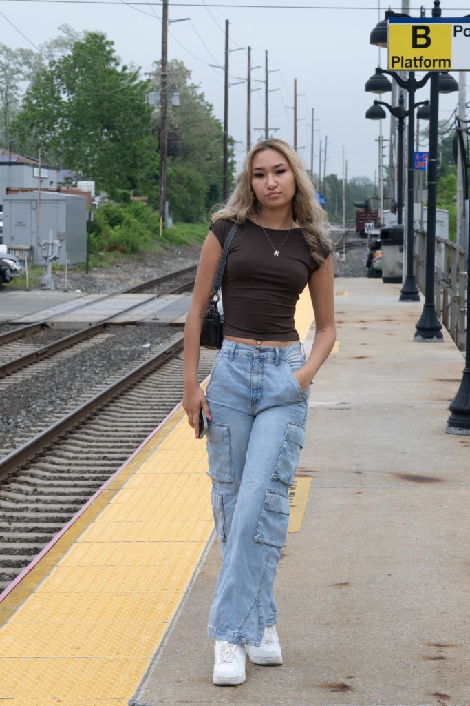 Kaylin Morales posing on the platform at the Bay Side LIRR station