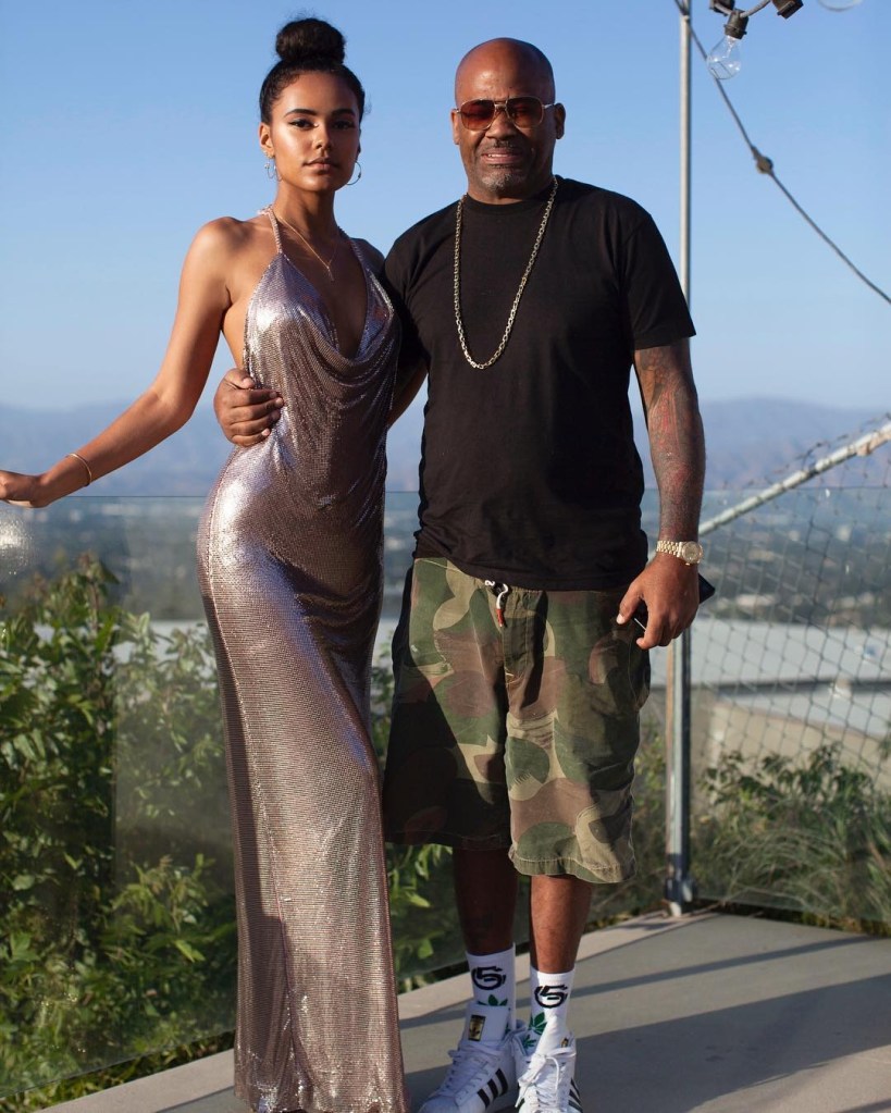 Damon Dash poses outside with daughter Ava, who wears a silver gown. 