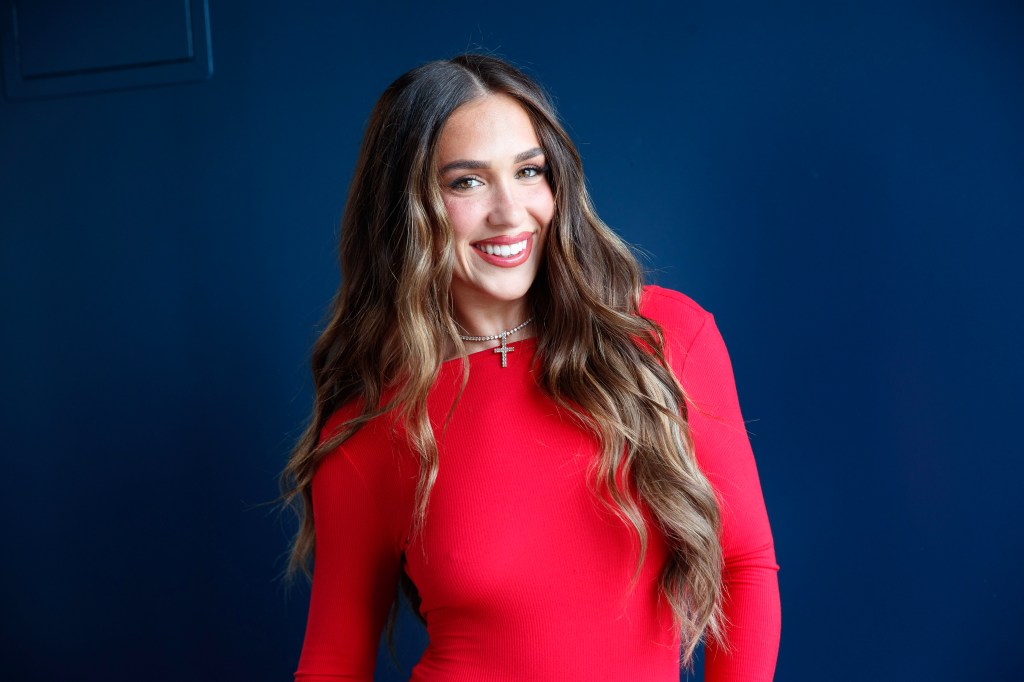 Ariana Bierman smiling red dress.