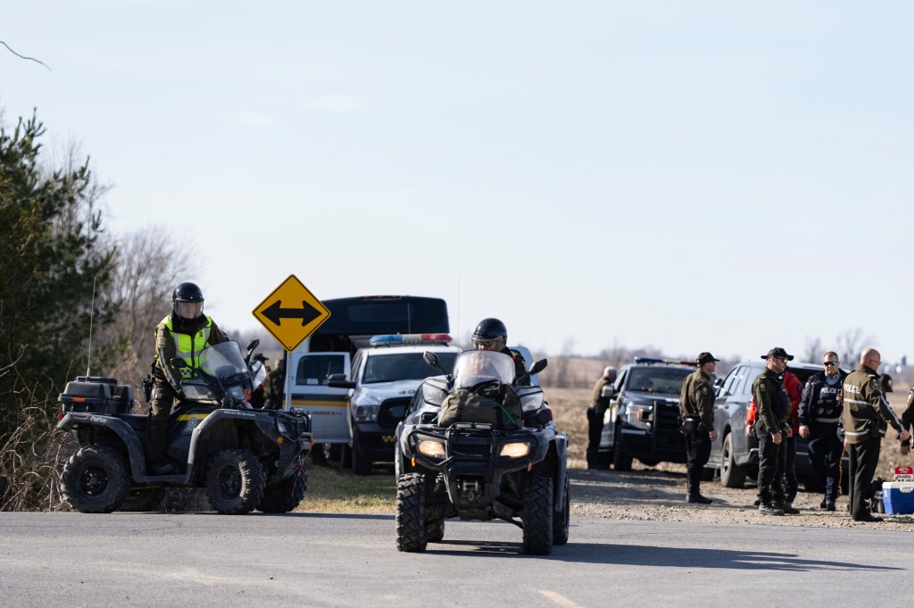 Trucks from police and border agents looking for people at the Canada-US border