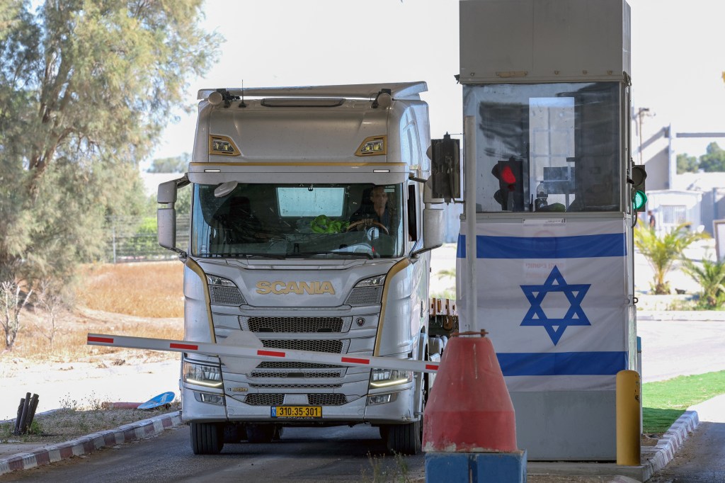 A truck carrying humanitarian aid drives through the Kerem Shalom crossing between southern Israel and the Gaza Strip, on May 29, 2025.