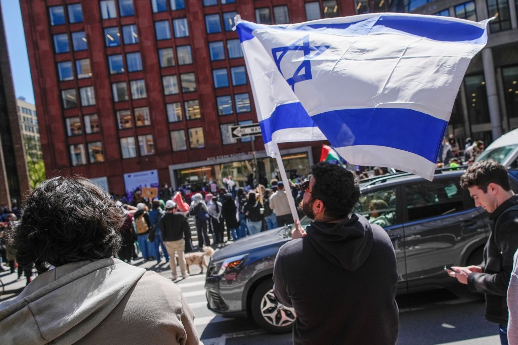 New York University students and pro-Israeli supporters rally in April 2024 across the street from where pro-Palestinian students and supporters rally outside the NYU Stern School of Business building.
