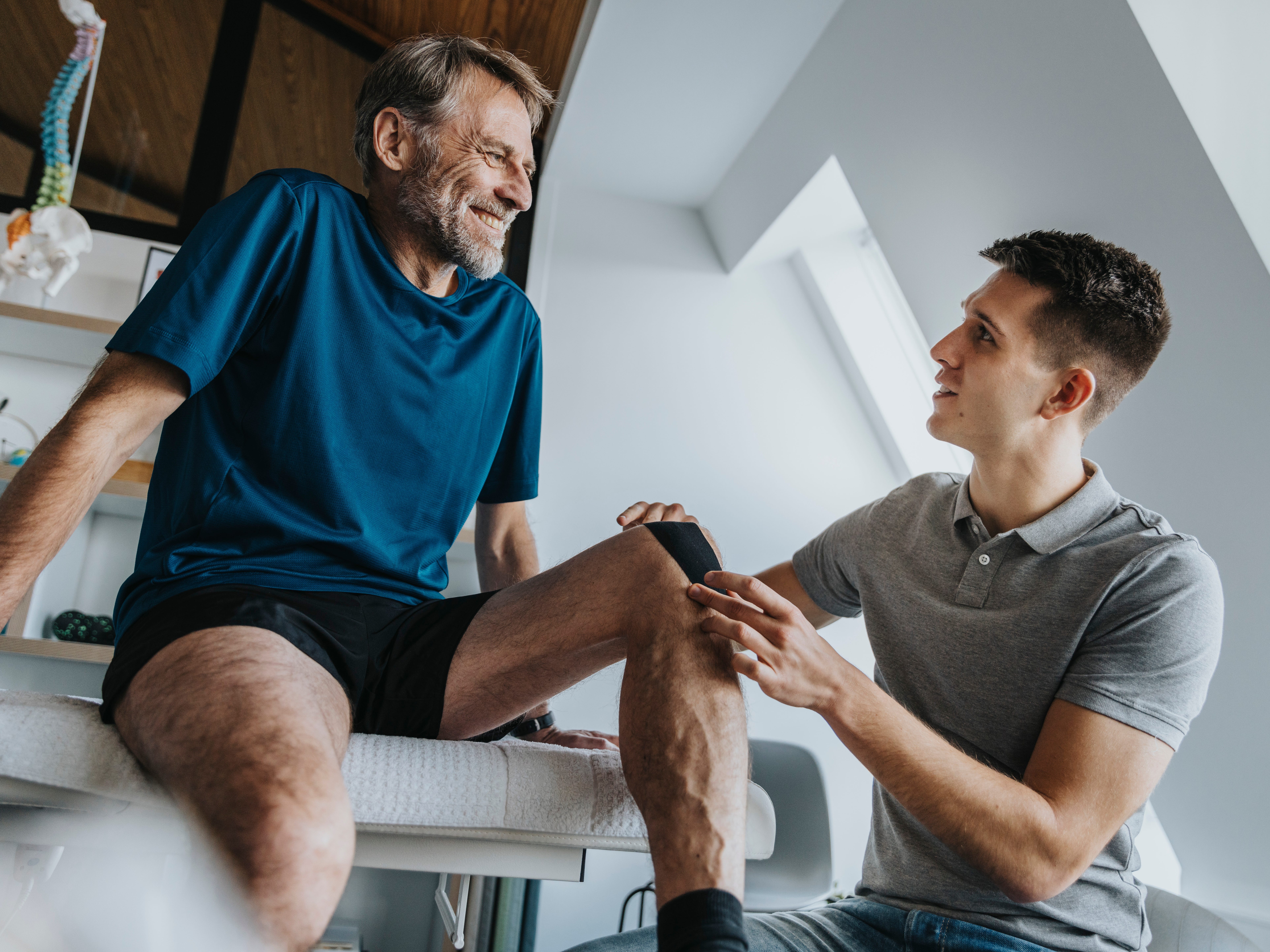Physical therapist helping a patient with their knee