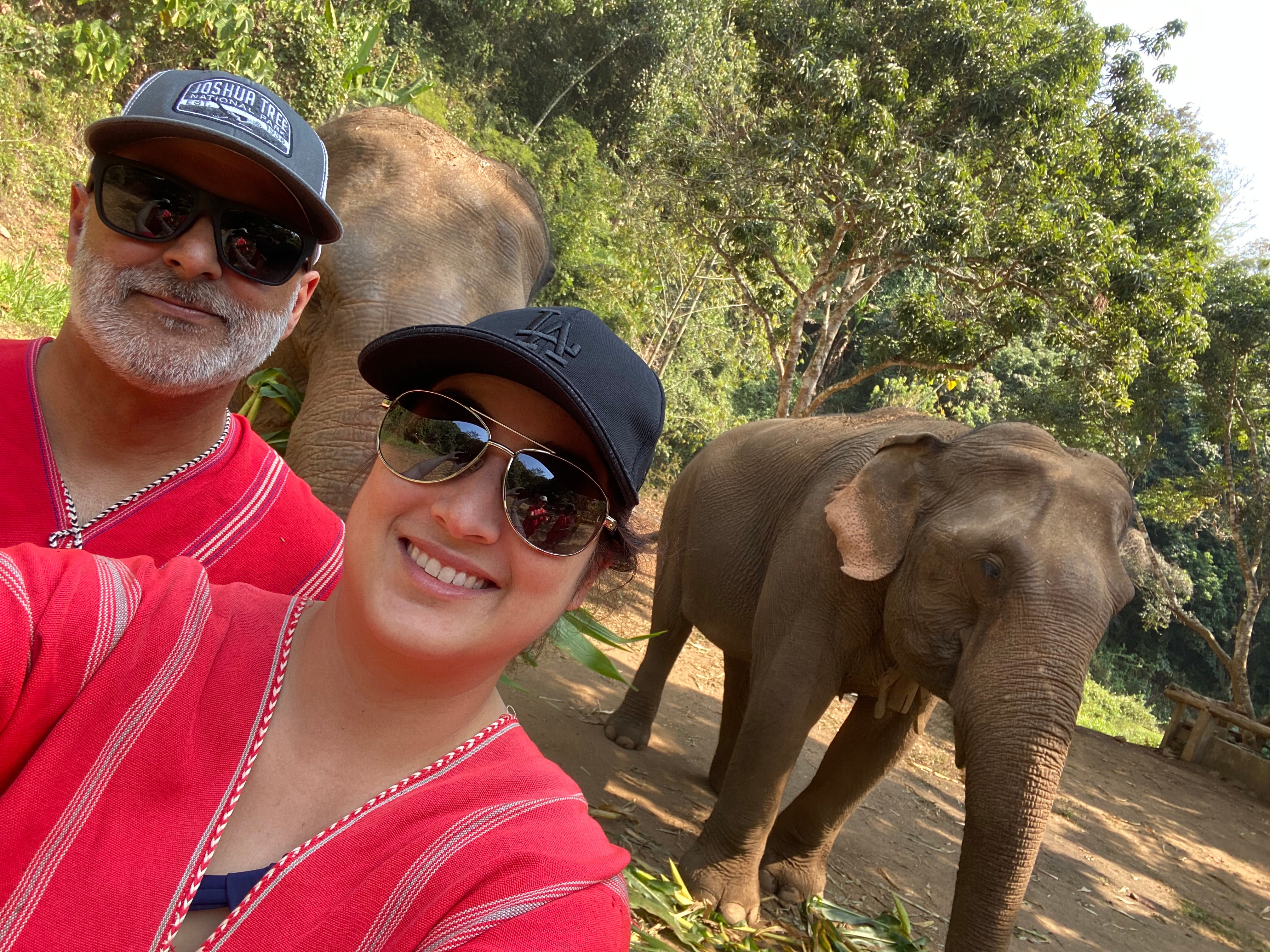 A couple posing with elephants in Chiang Mai.