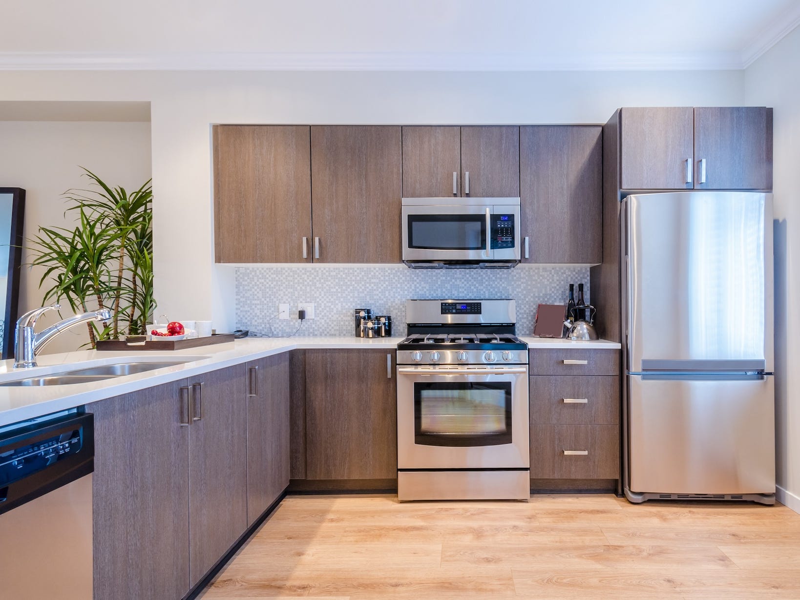 A kitchen with brown cabinets and stainless steel appliances.
